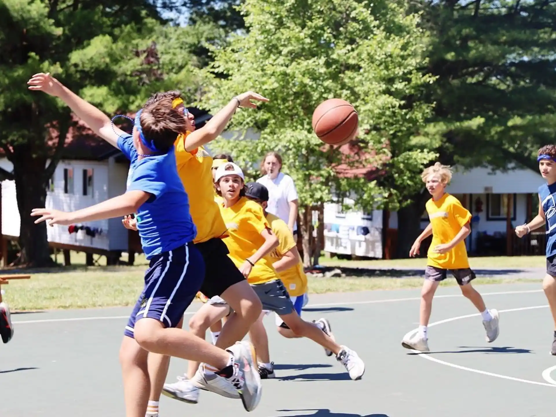 a group of people playing basketball
