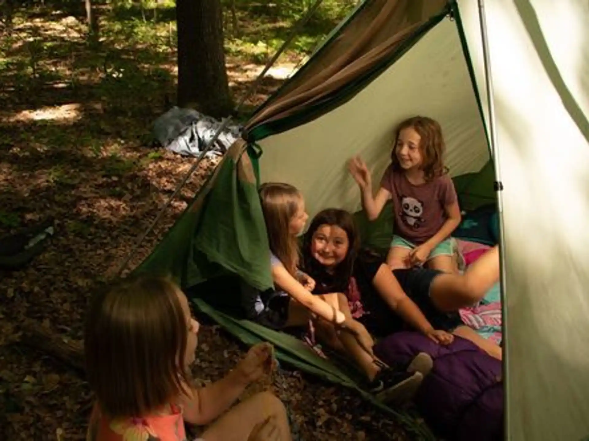 a group of people sitting in a tent