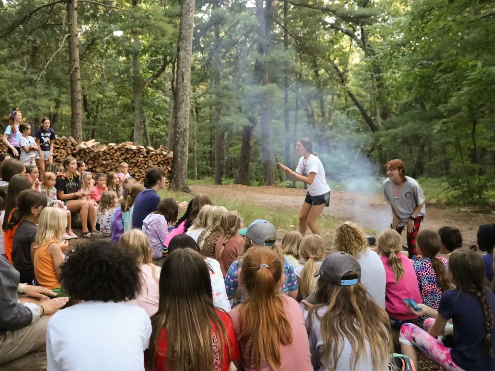 a group of people watching a person play a guitar in front of a crowd