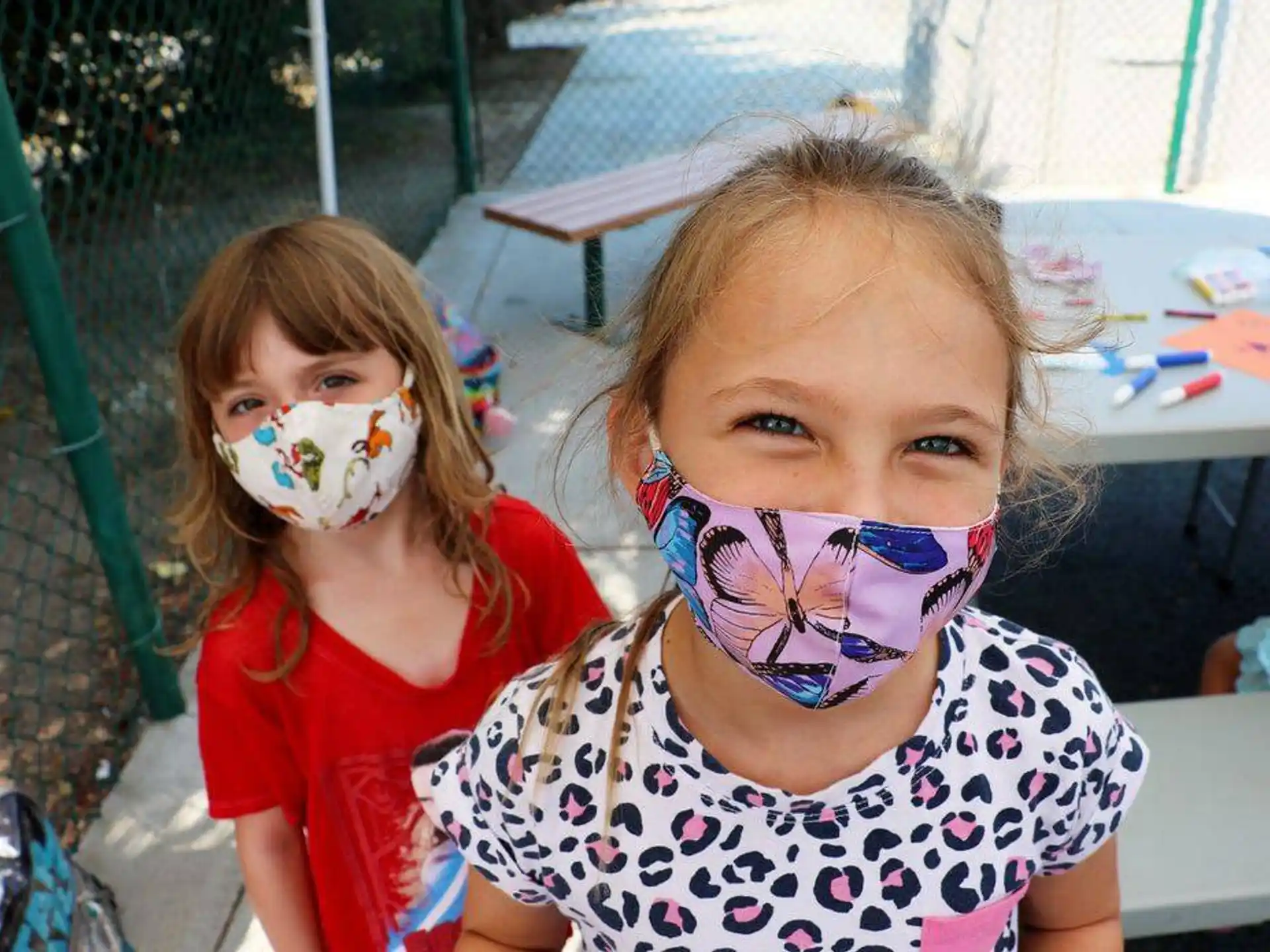 a couple of girls with paint on their faces