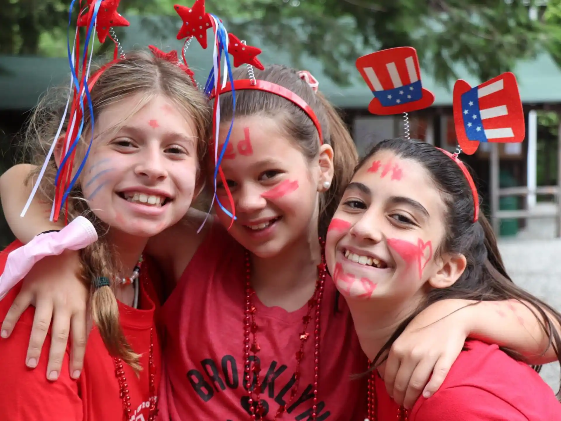 a group of girls wearing red and blue hats