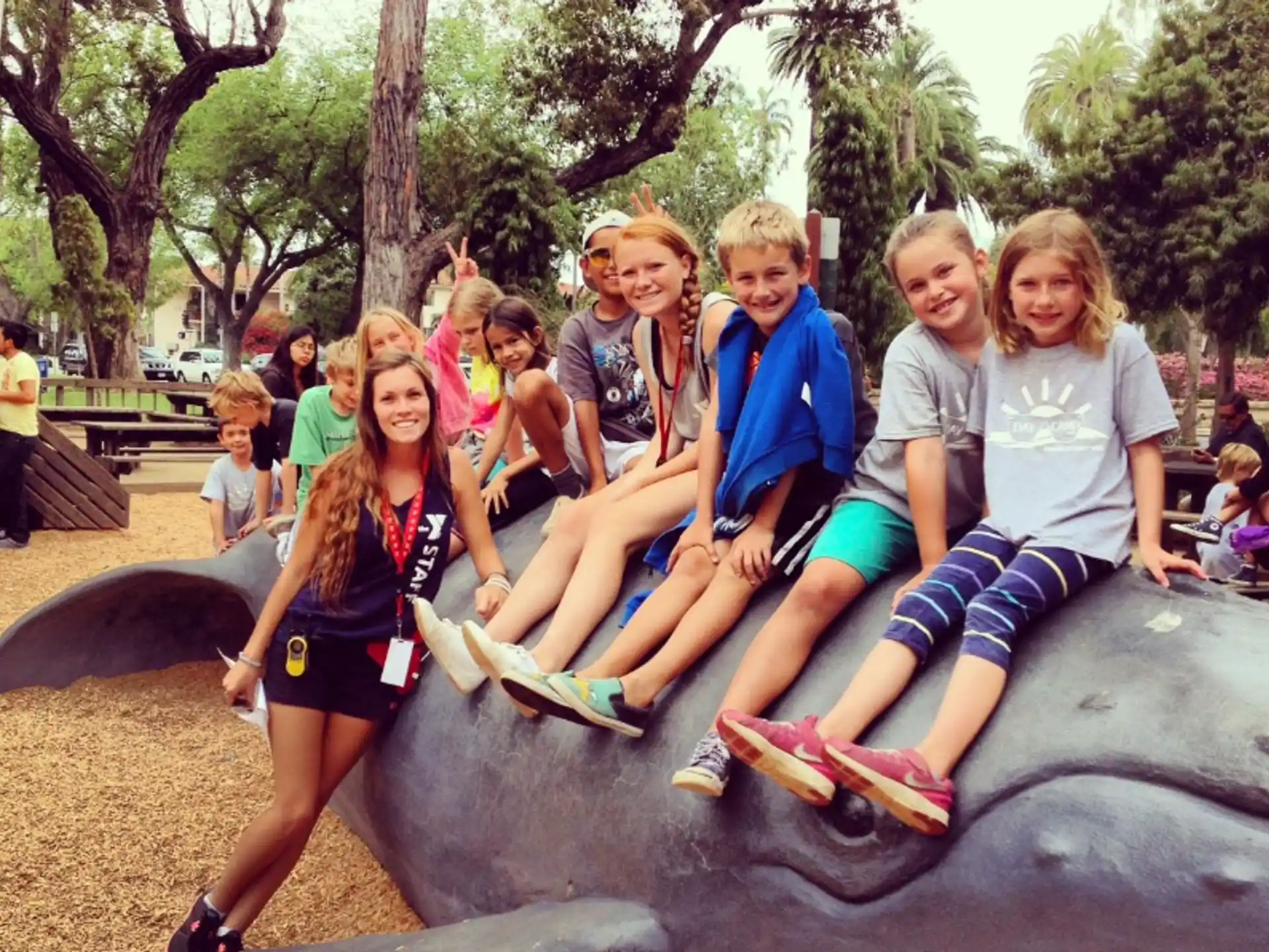a group of people sitting on a rock posing for the camera