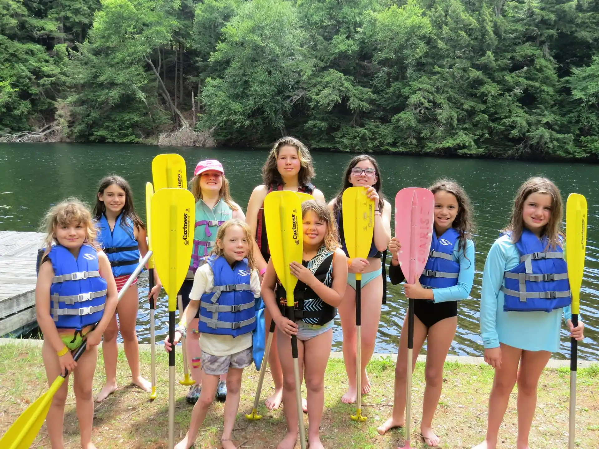 a group of girls holding paddles