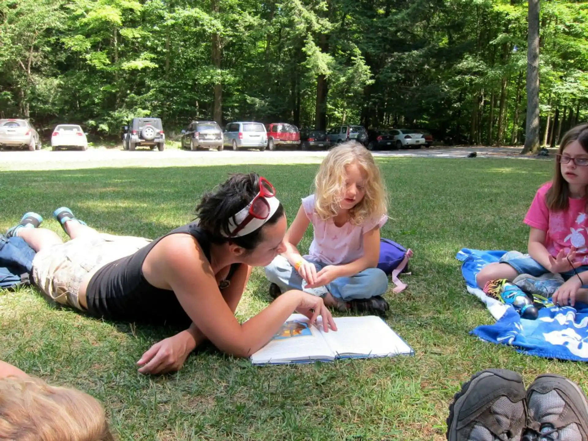 a group of people sitting on the grass
