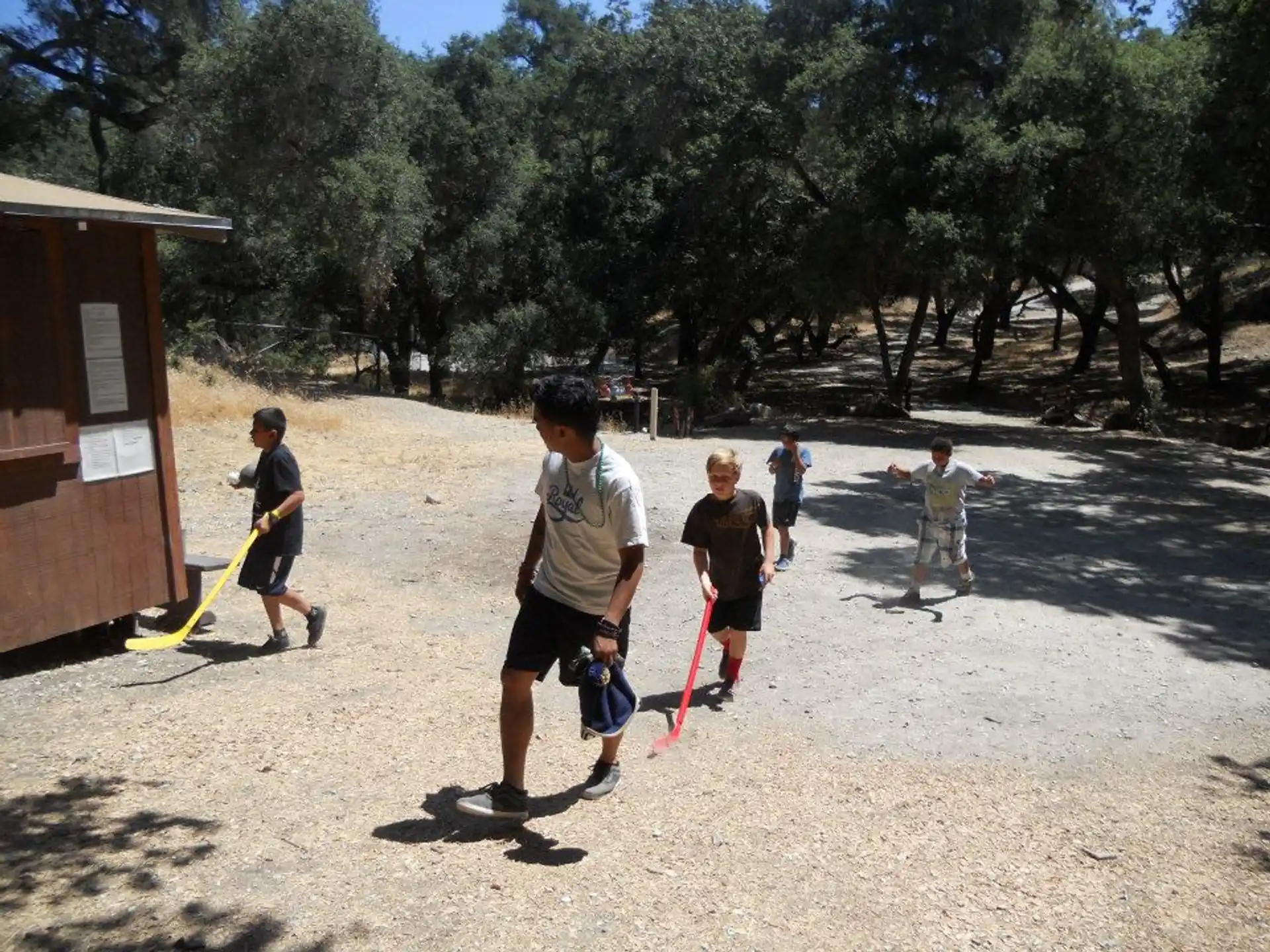 a group of people playing with sticks