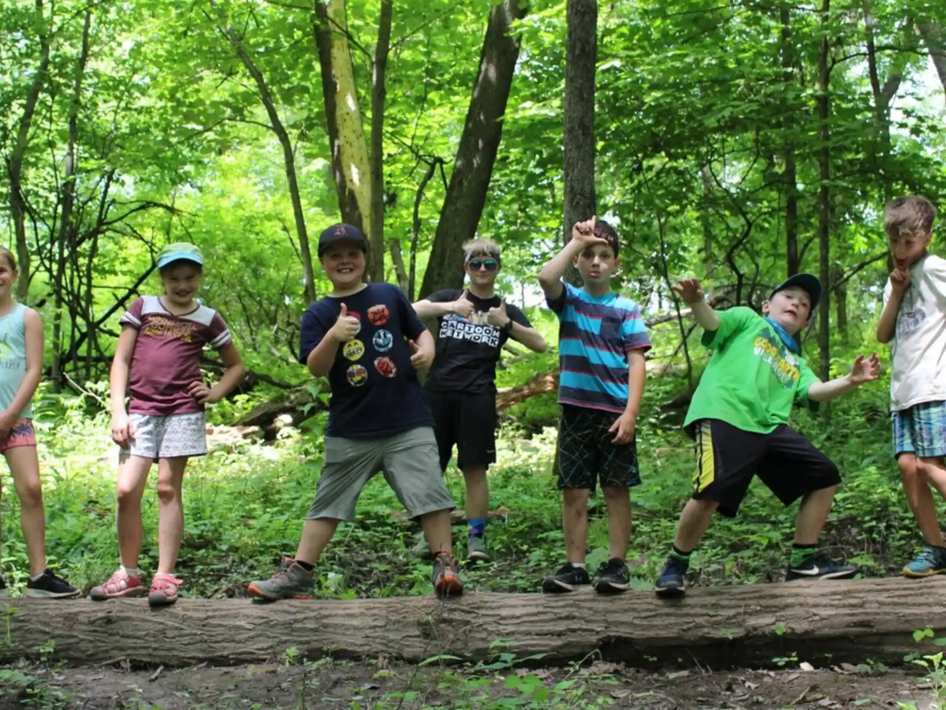 a group of people posing for a photo in the woods
