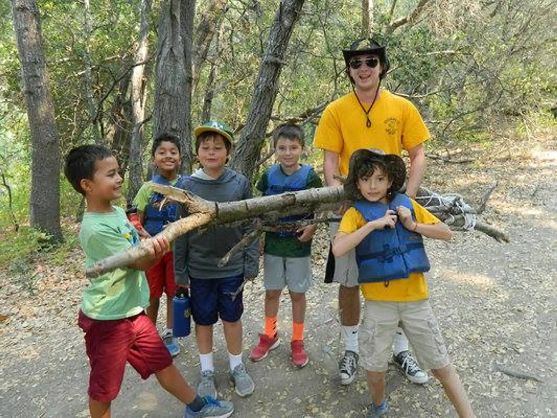 a group of kids running in the woods