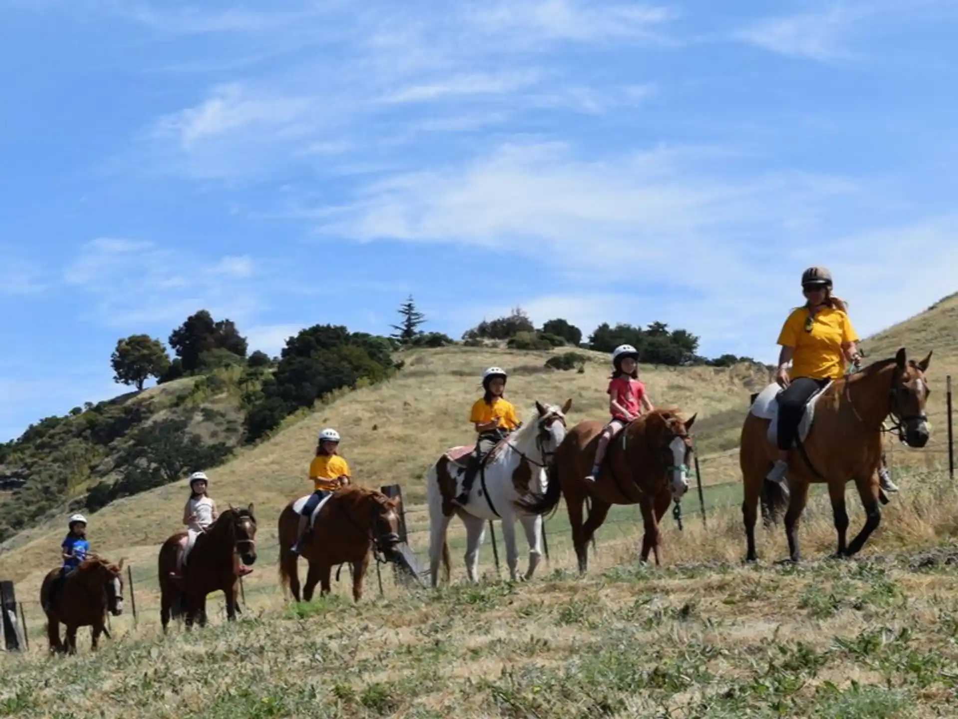 a group of people riding horses