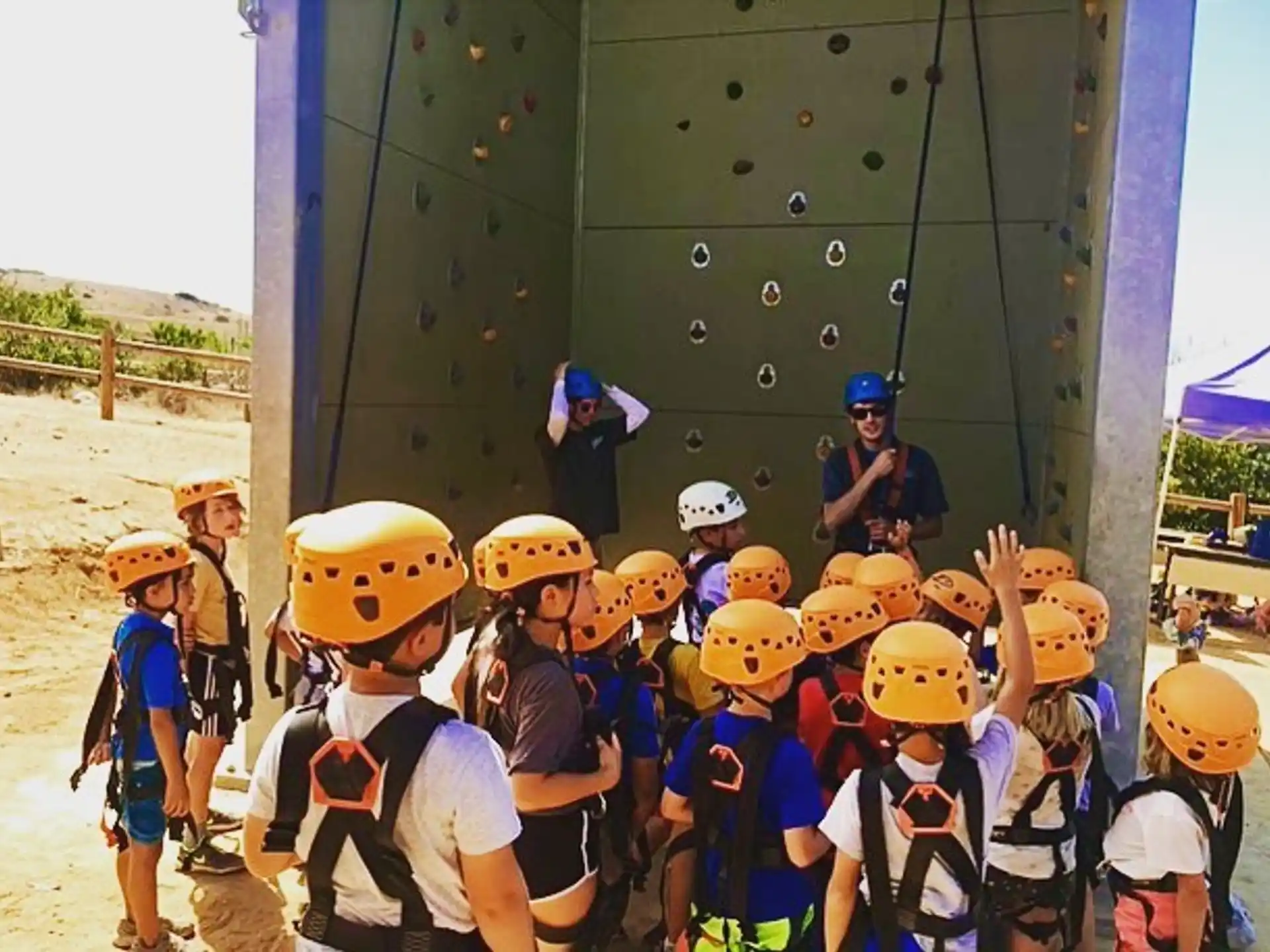 a group of kids wearing hardhats and helmets