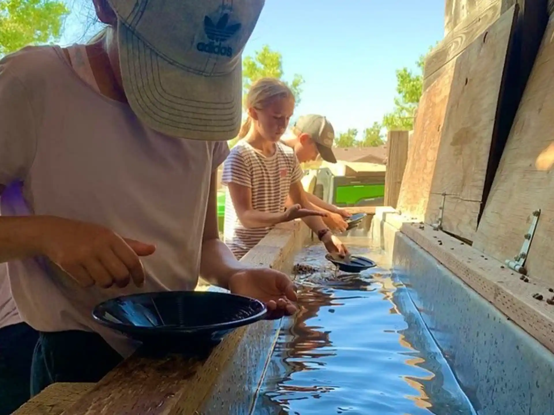 a man and a couple of children cooking outside