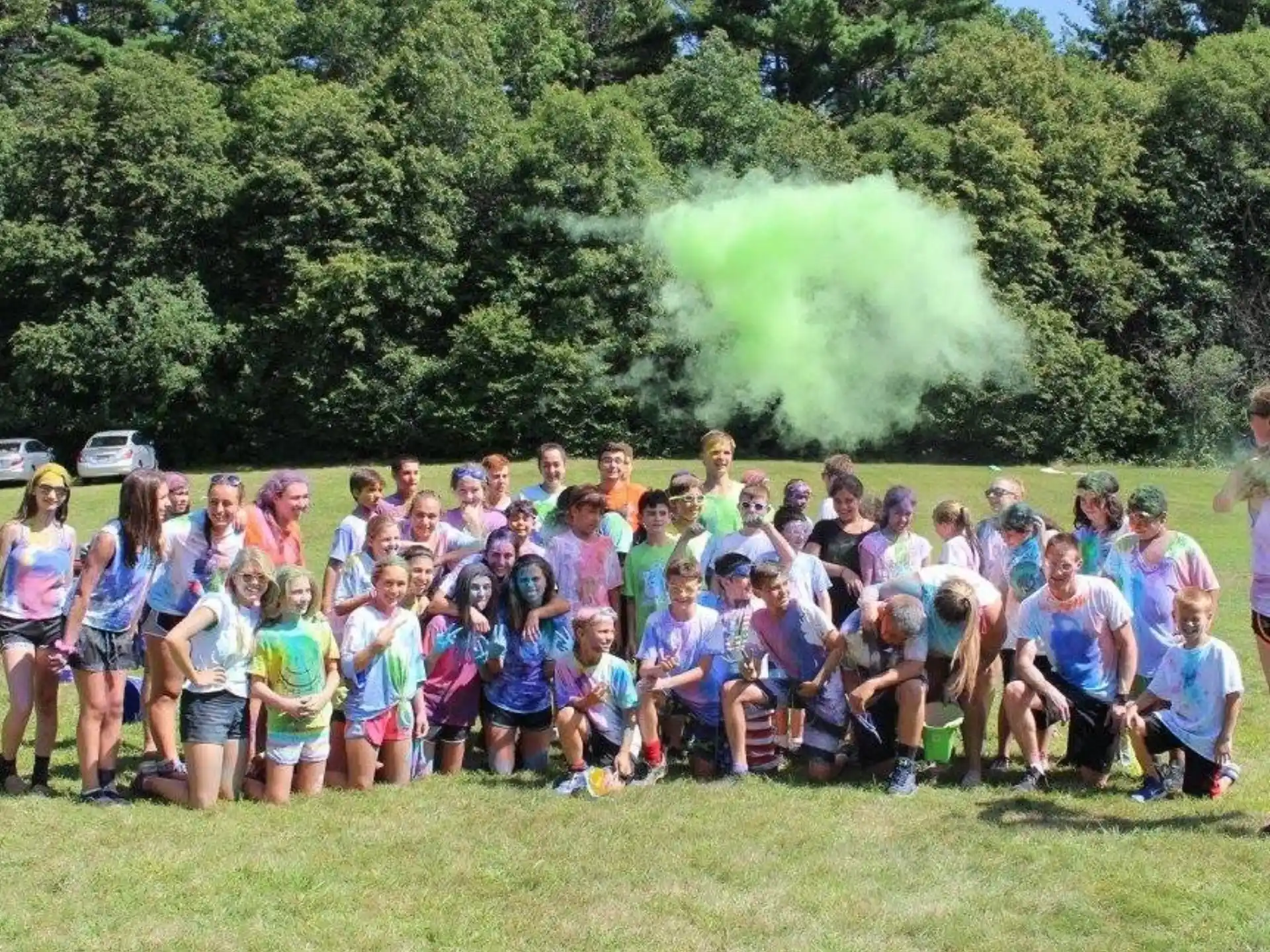 a group of people posing for a photo in front of a fire
