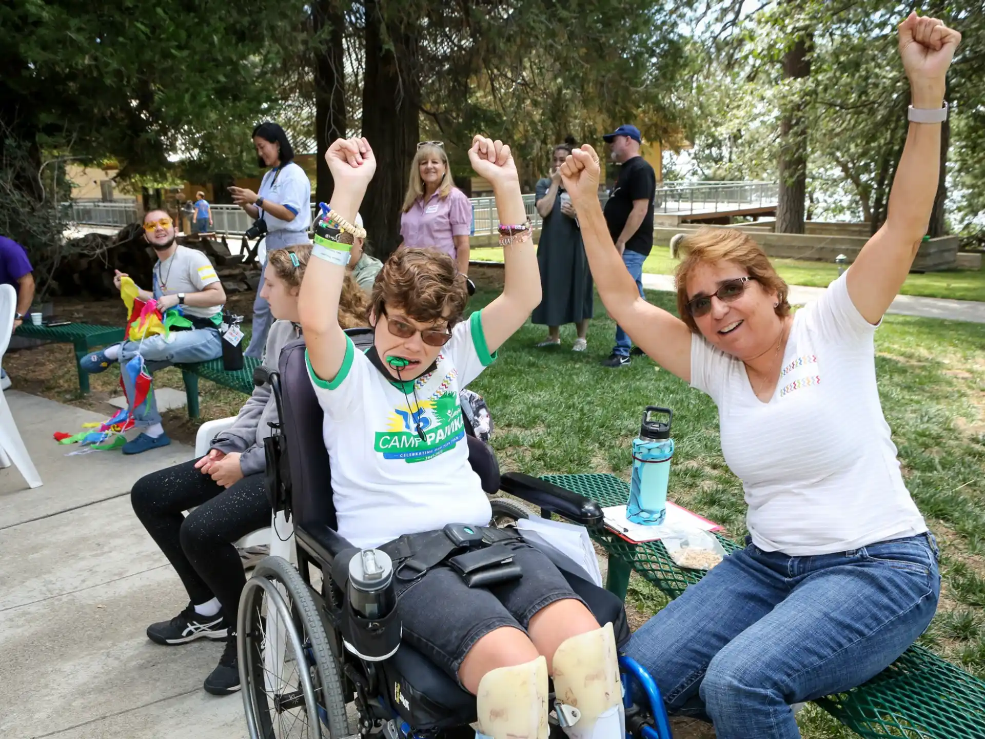 a person in a wheelchair with a person in a wheelchair with a bottle of water and a group