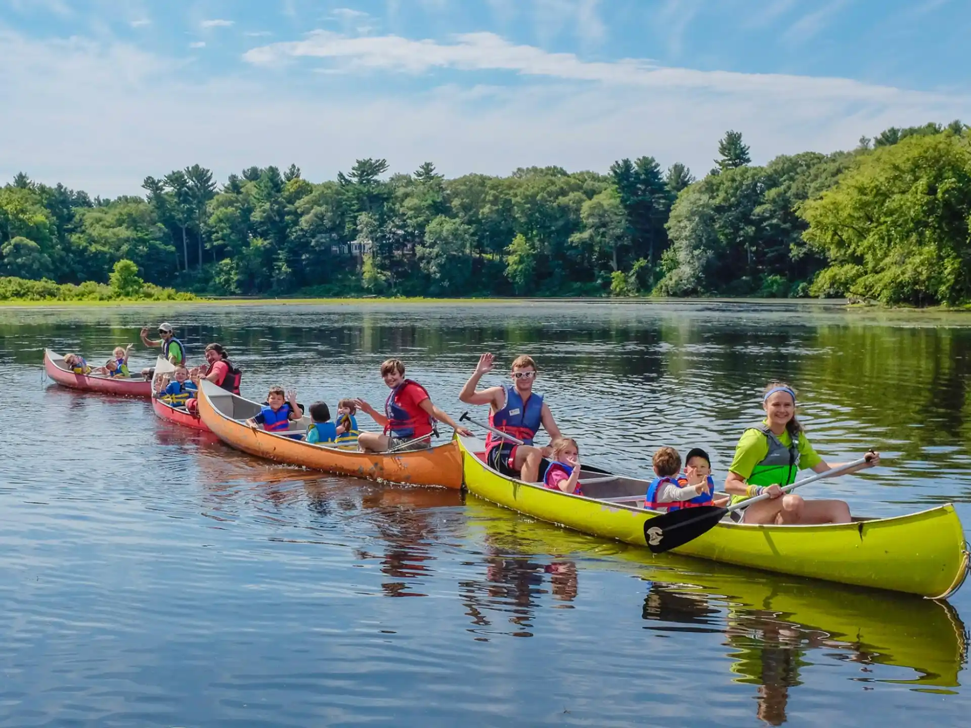 a group of people in canoes on a river