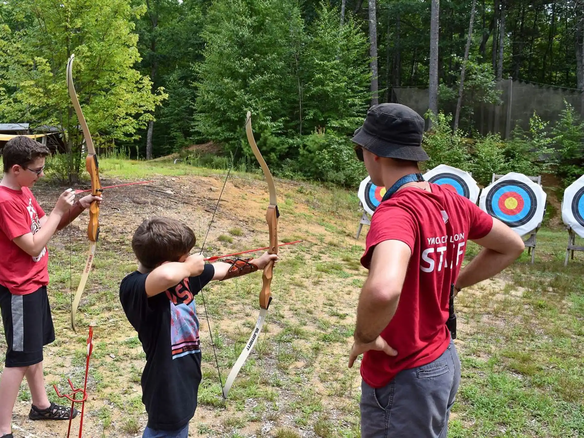 a group of people shooting bows
