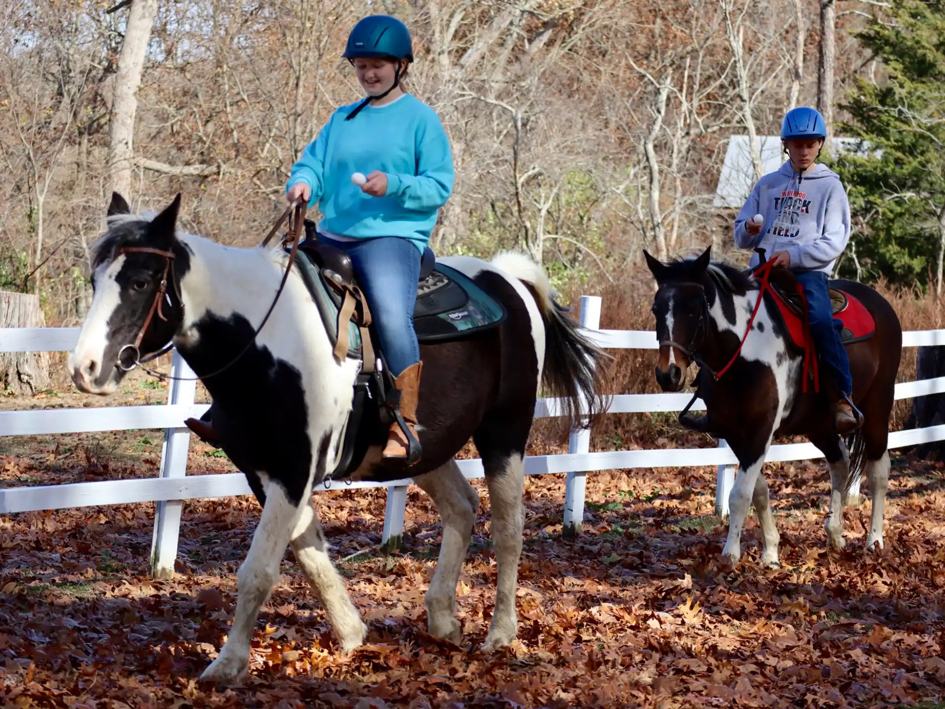 a couple of people riding horses