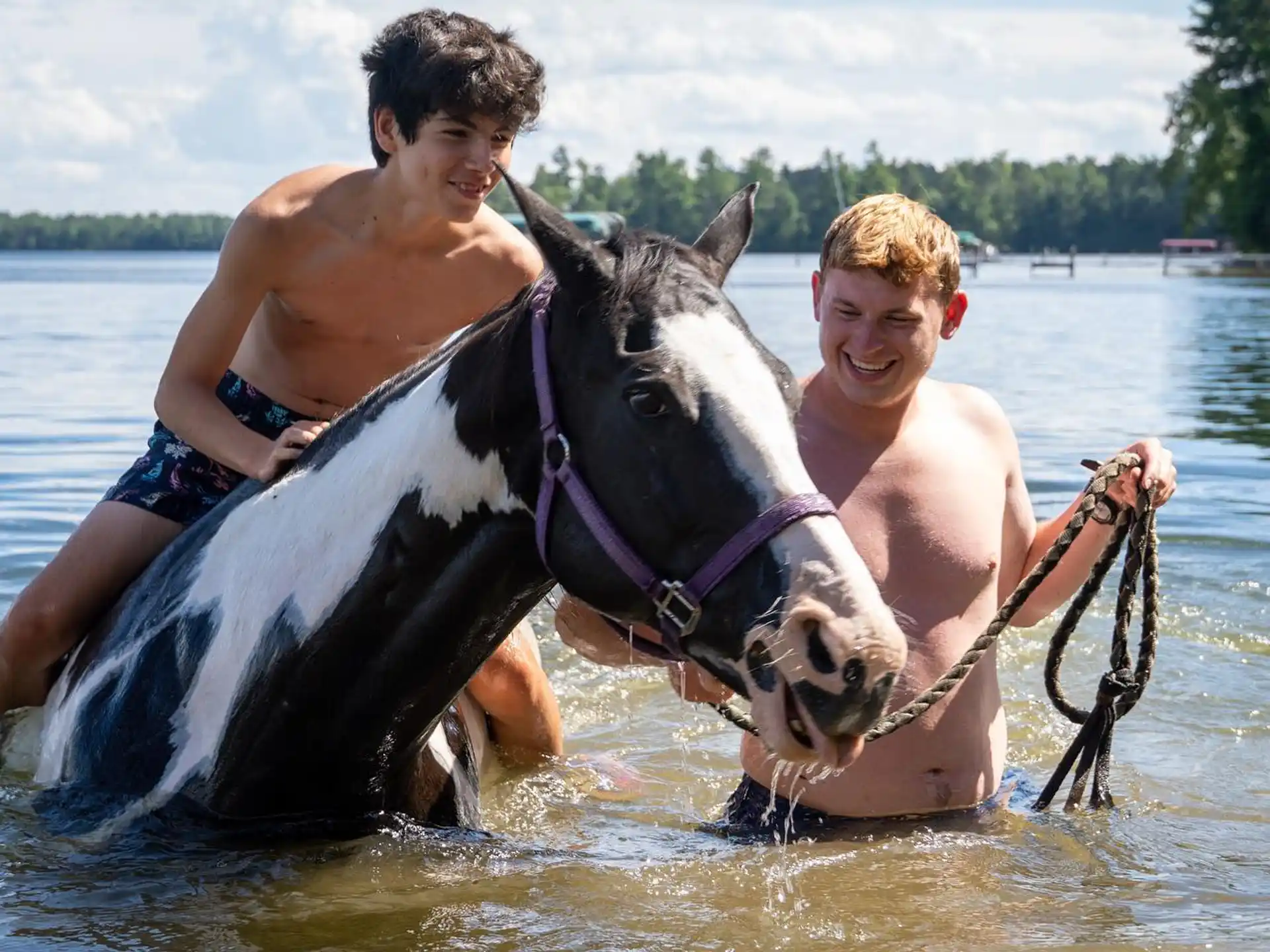 two men riding a dolphin