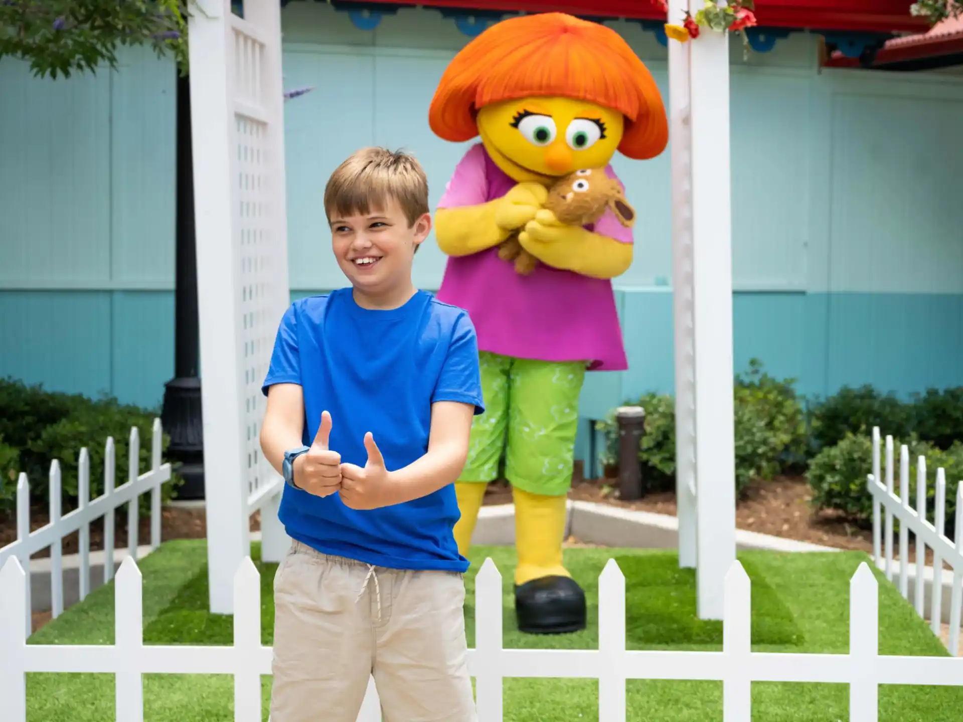 a boy standing next to a person in a garment