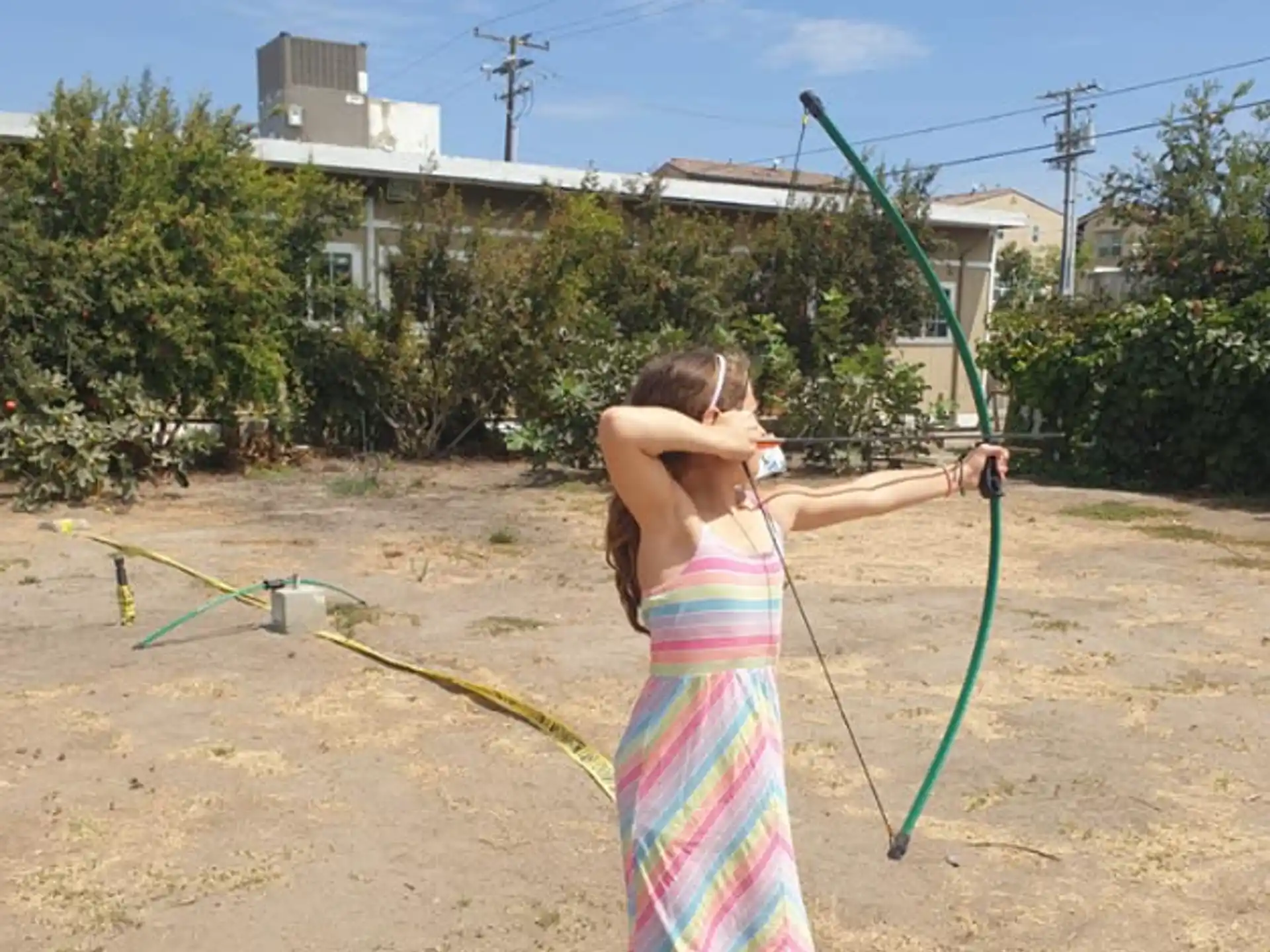 a person in a swimsuit holding a hose
