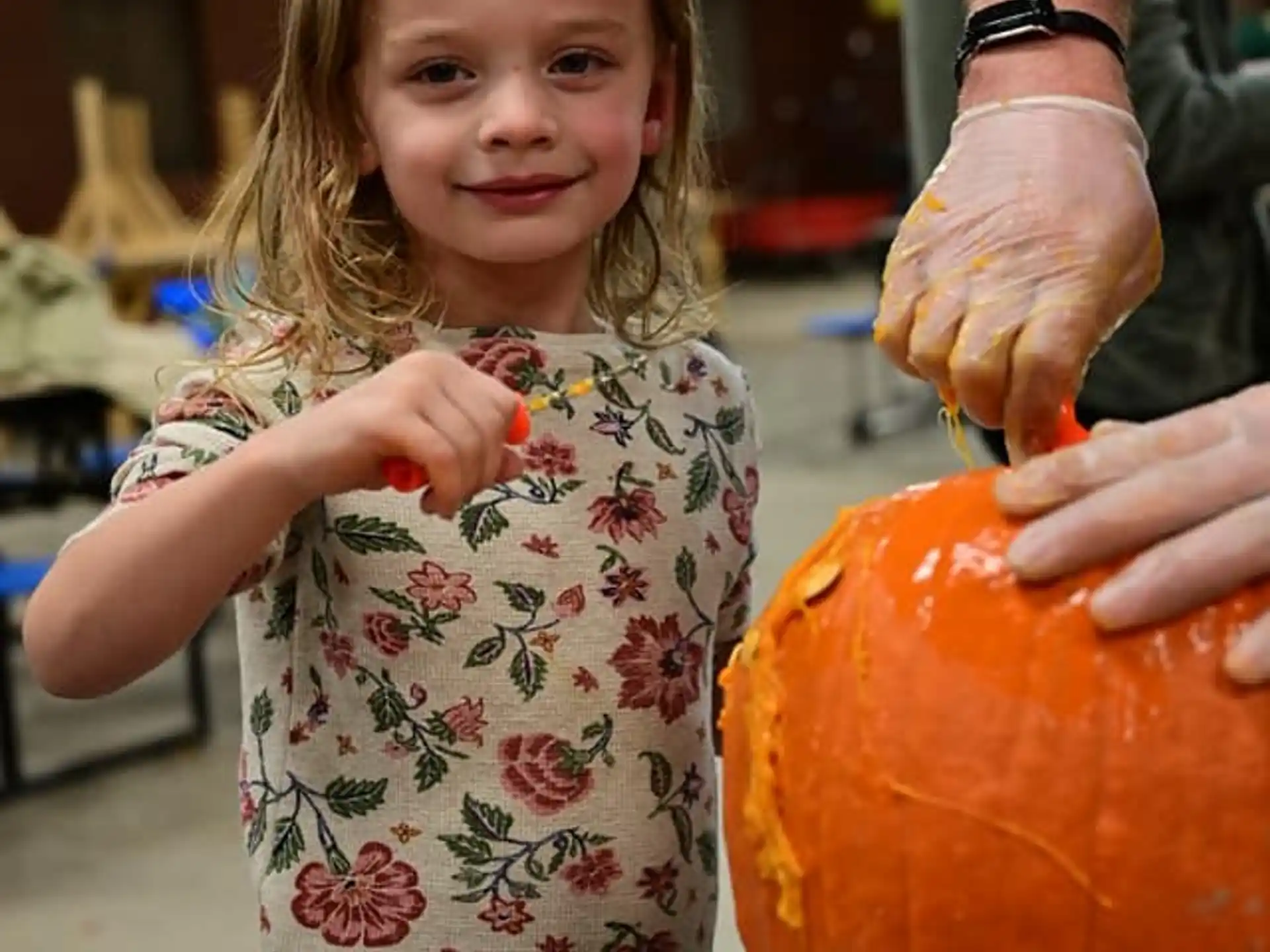 a girl holding a pumpkin