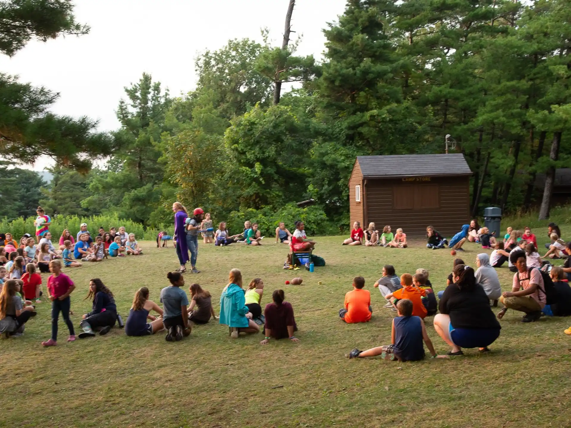 a group of people sitting on the ground outside