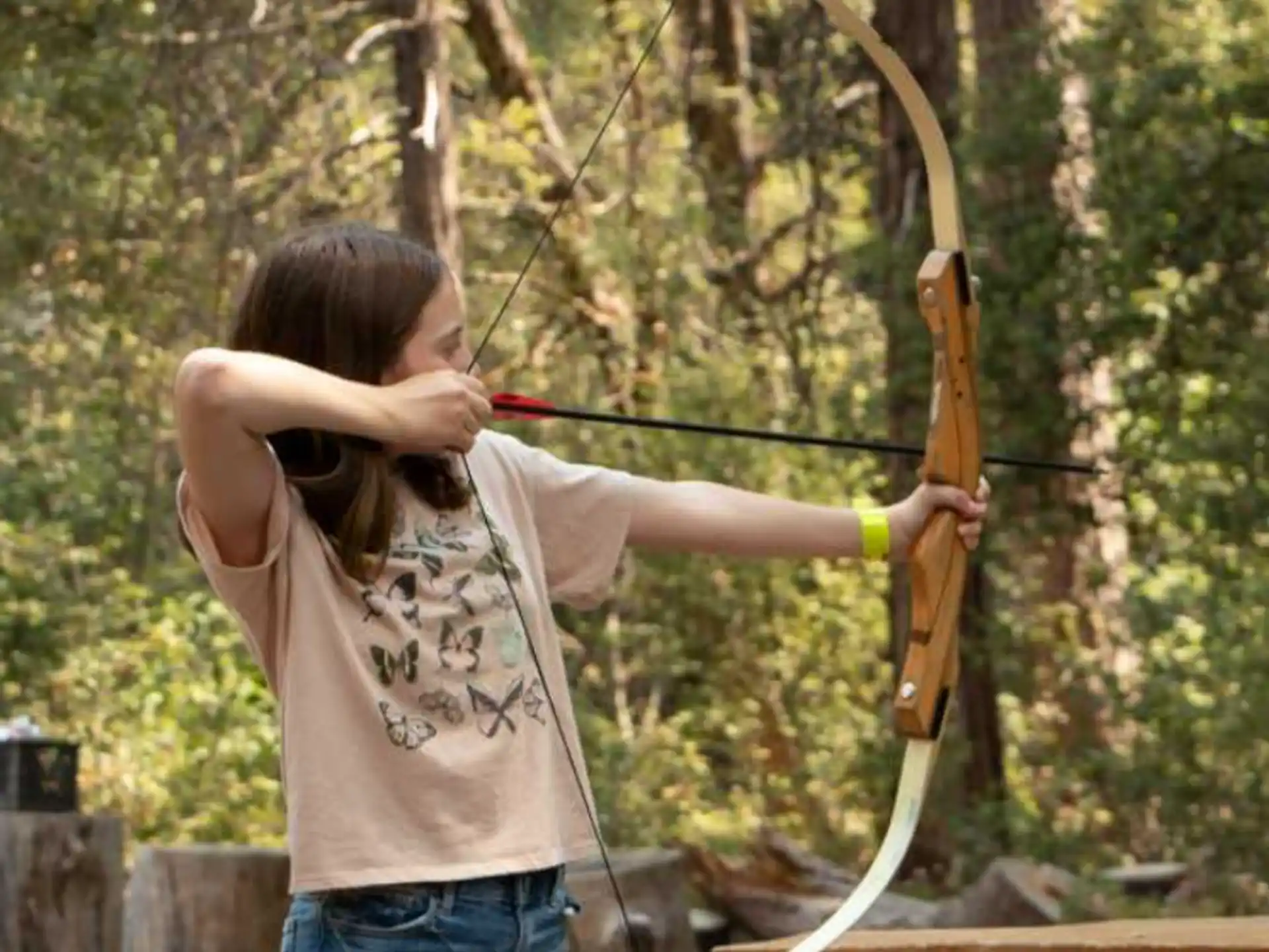 a girl holding a bow and arrow