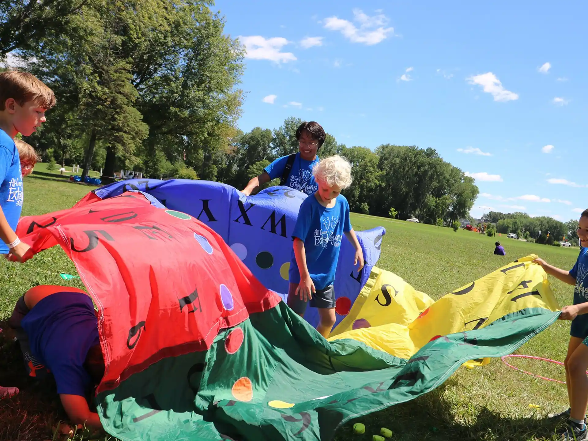 a group of kids playing in a large colorful tent