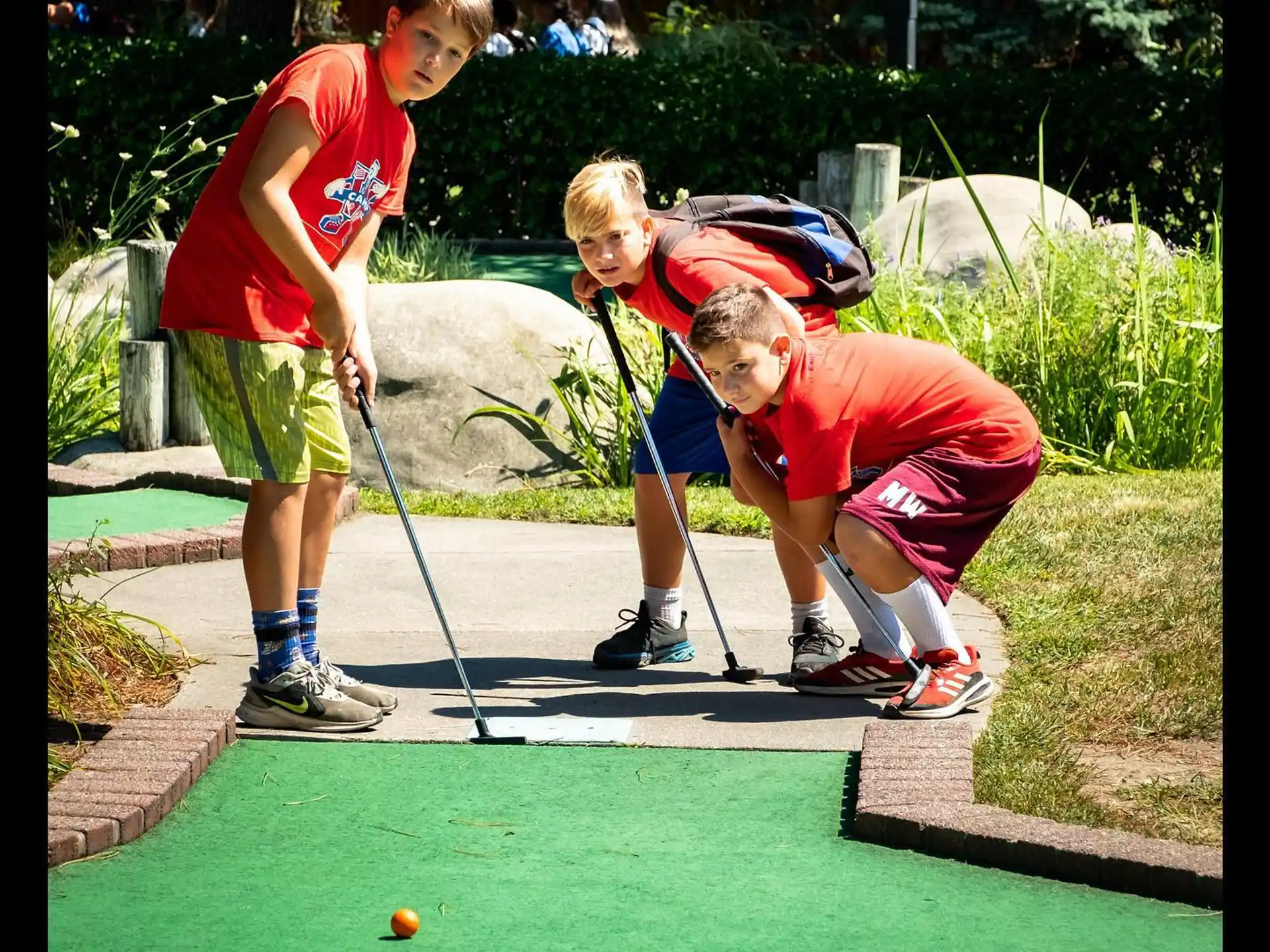 a couple of kids playing golf