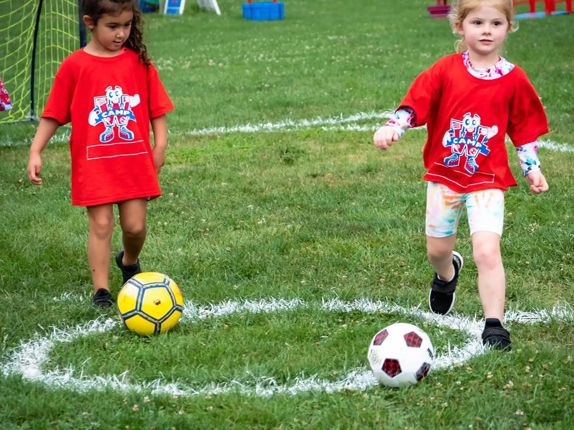 a couple of young girls playing football