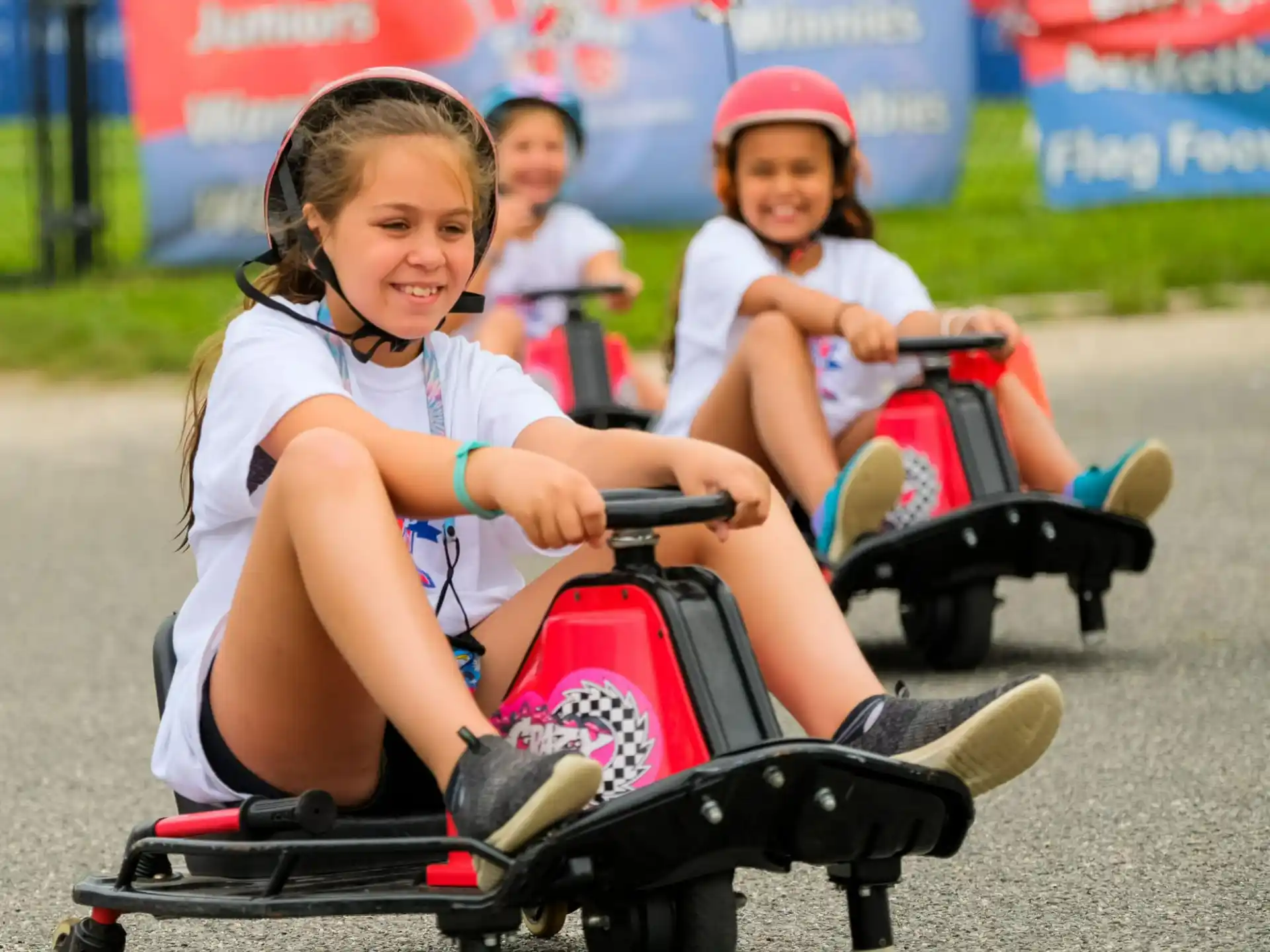 a group of kids riding on a small vehicle