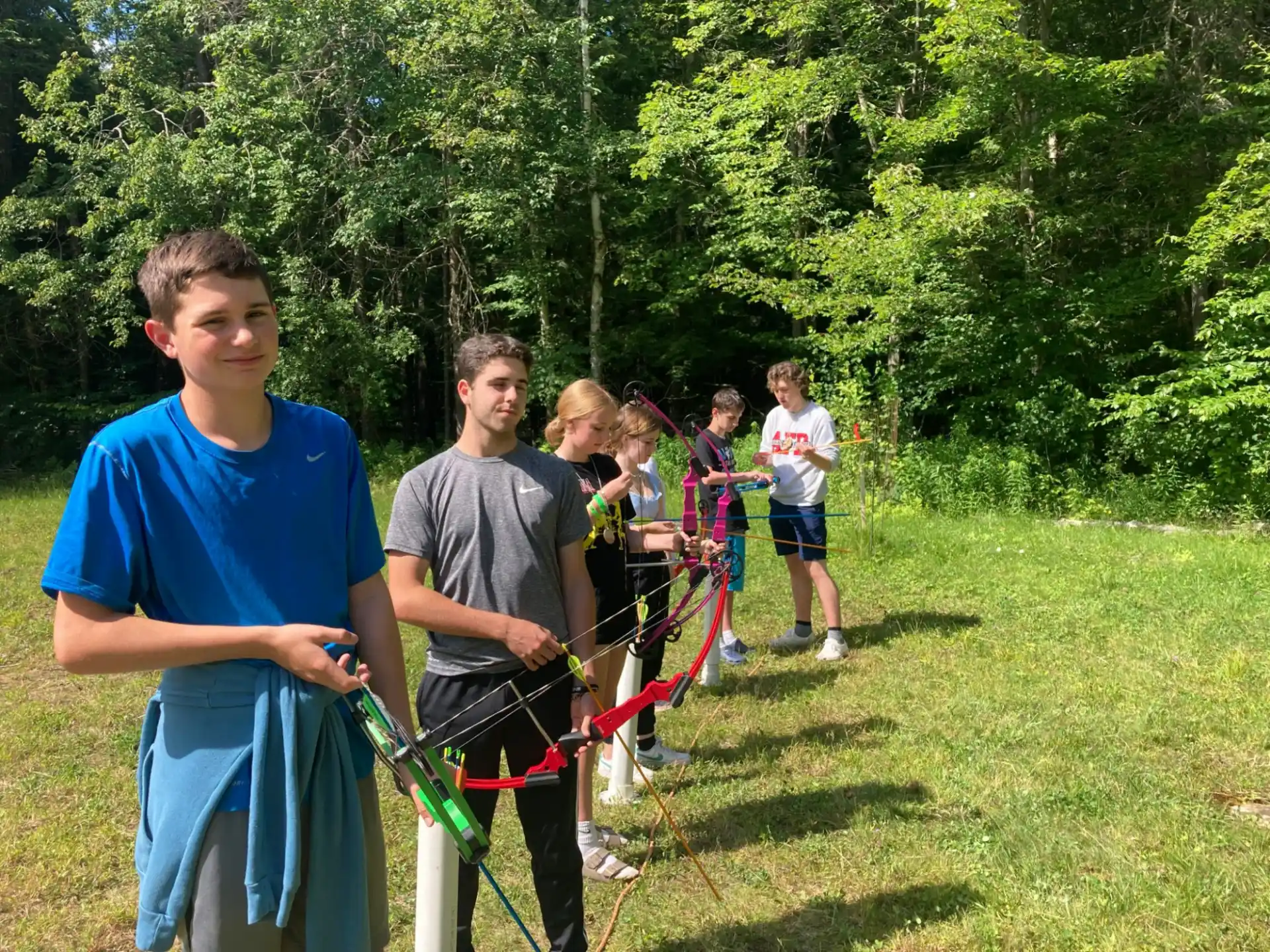 a group of people holding bows and arrows