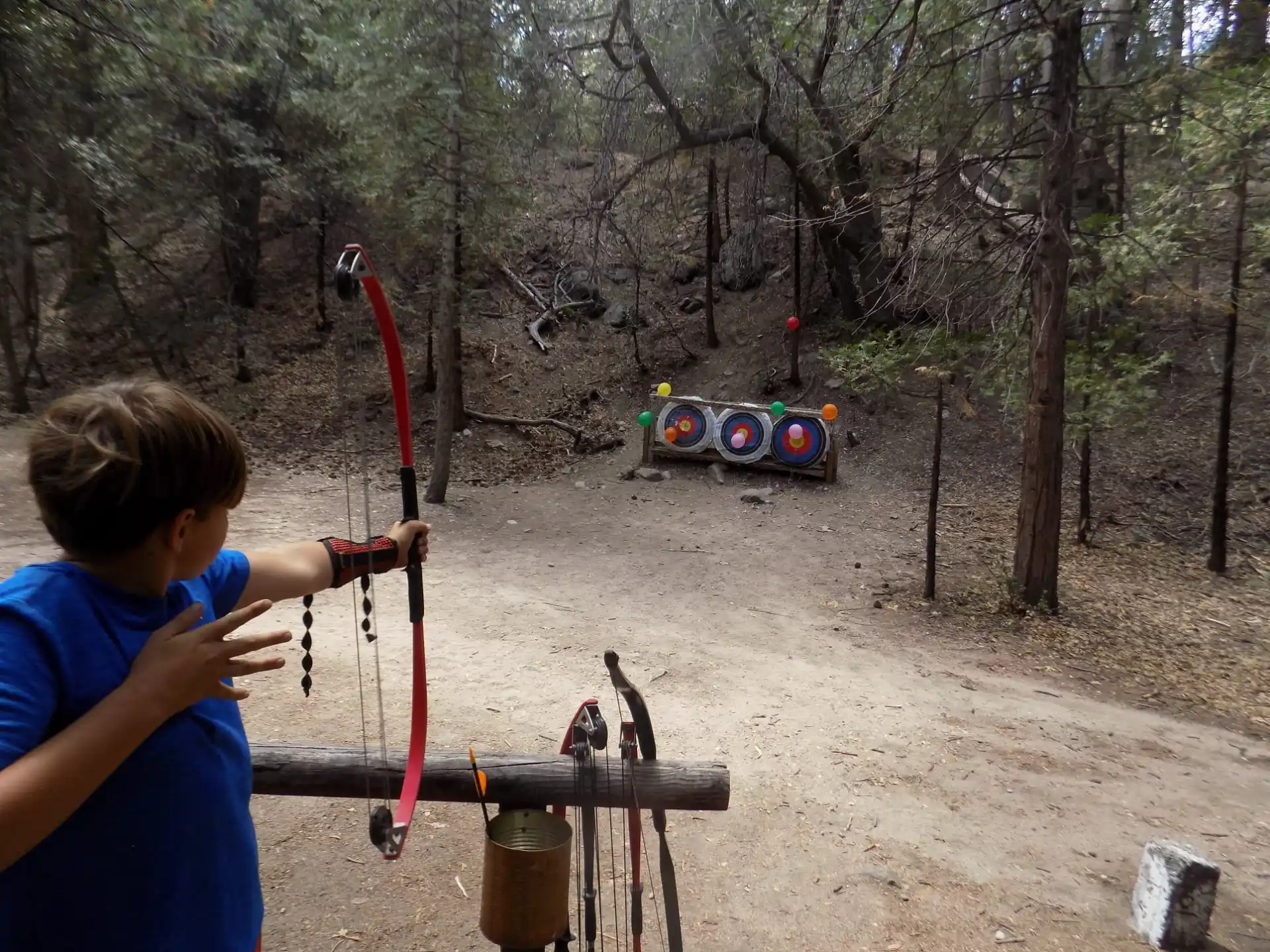 a boy shooting a bow and arrow