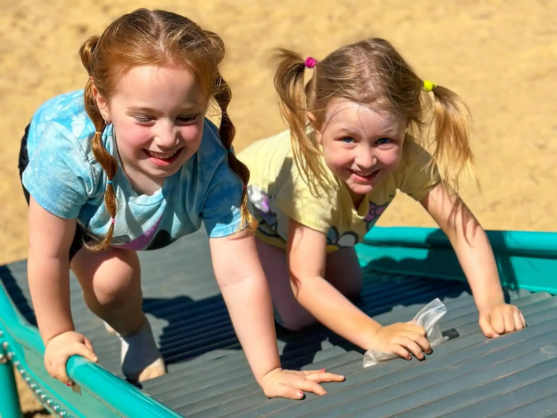 a couple of girls playing on a playground