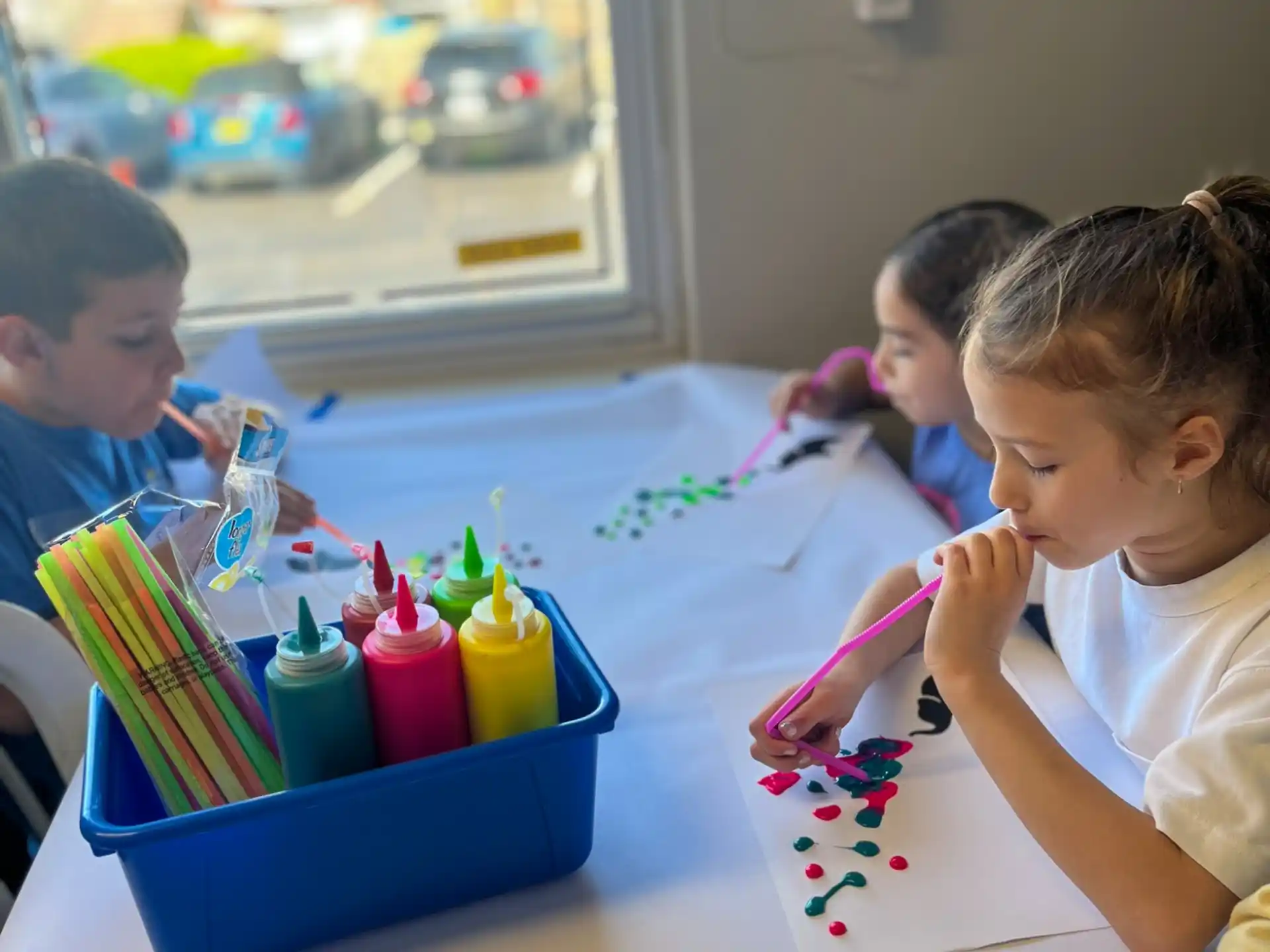 children painting on a table