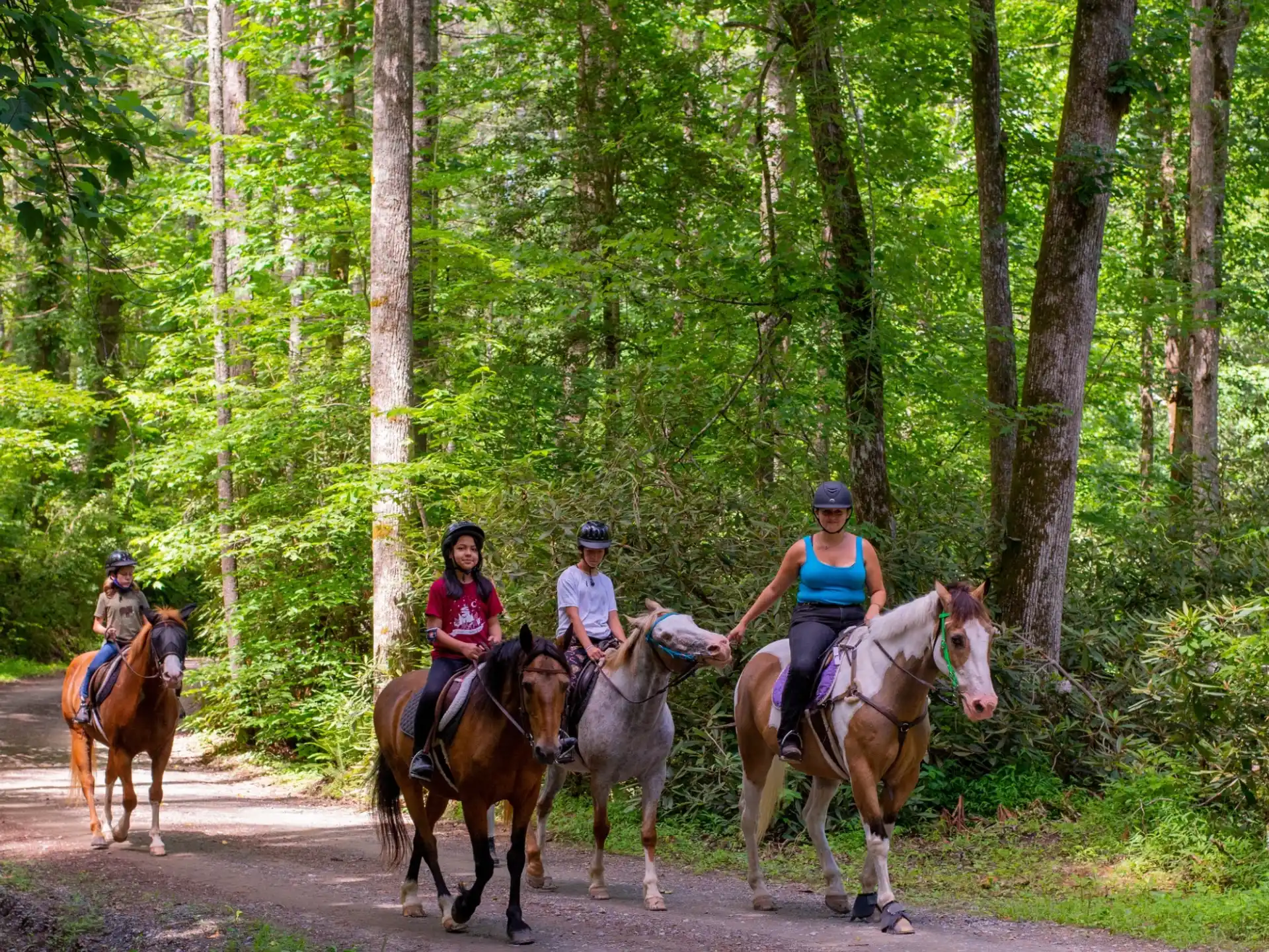 a group of people riding horses