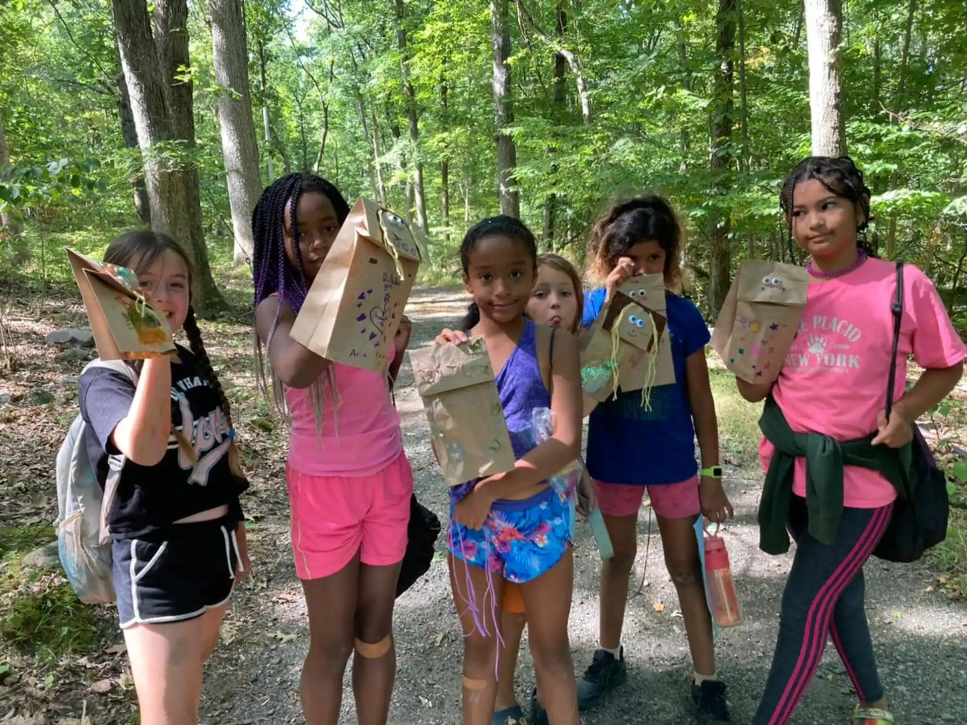 a group of girls holding bags