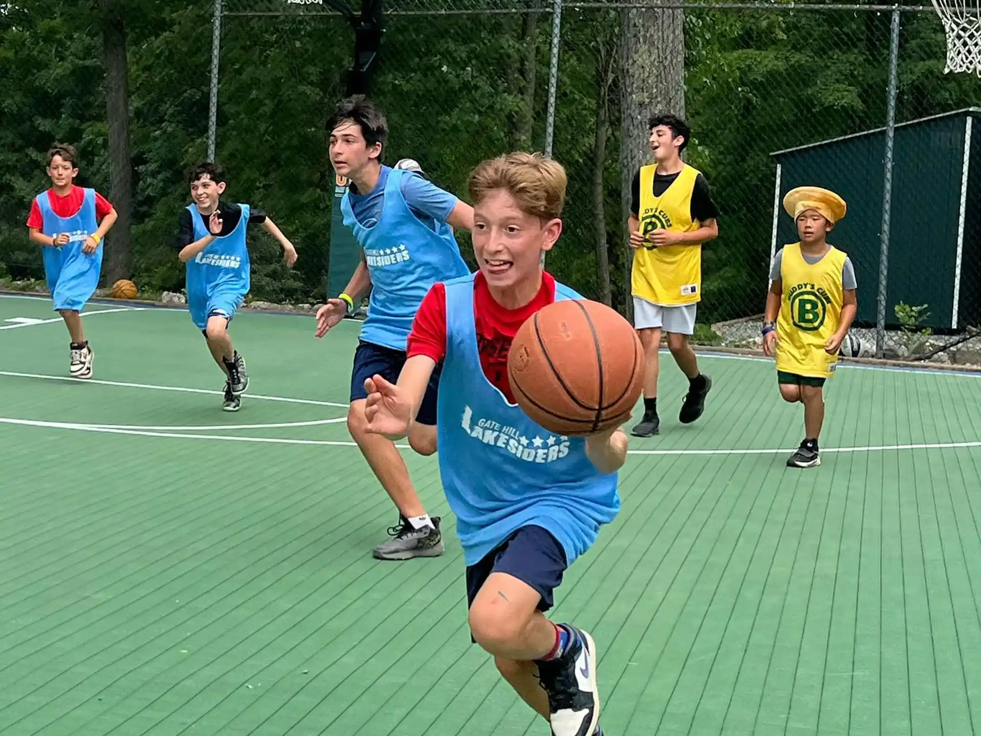 a group of kids playing basketball