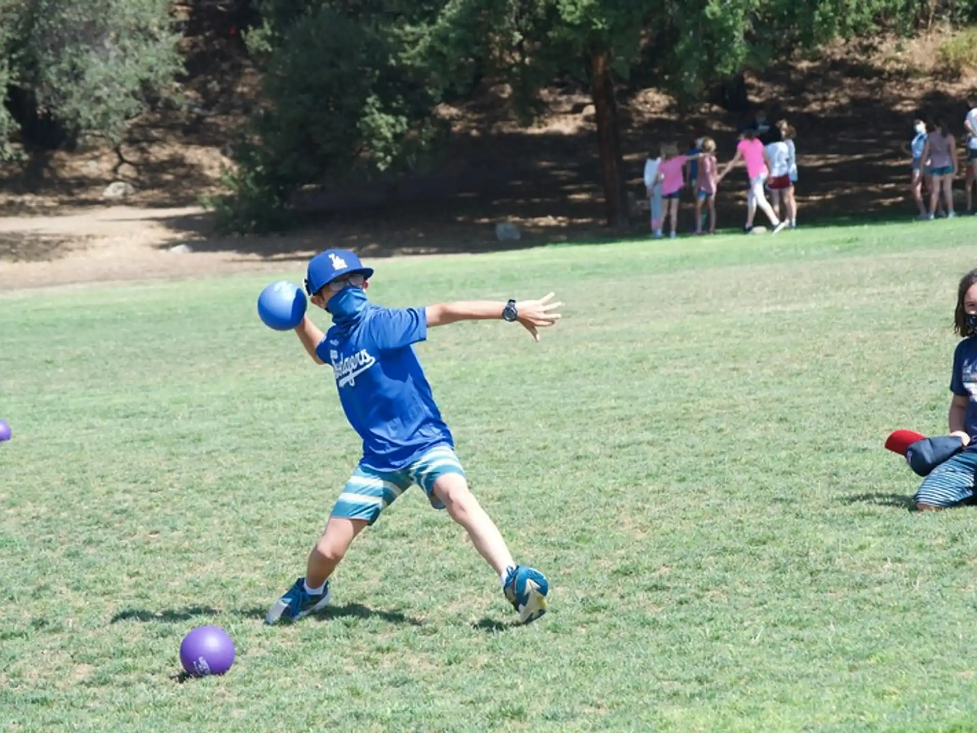 a kid playing with a ball