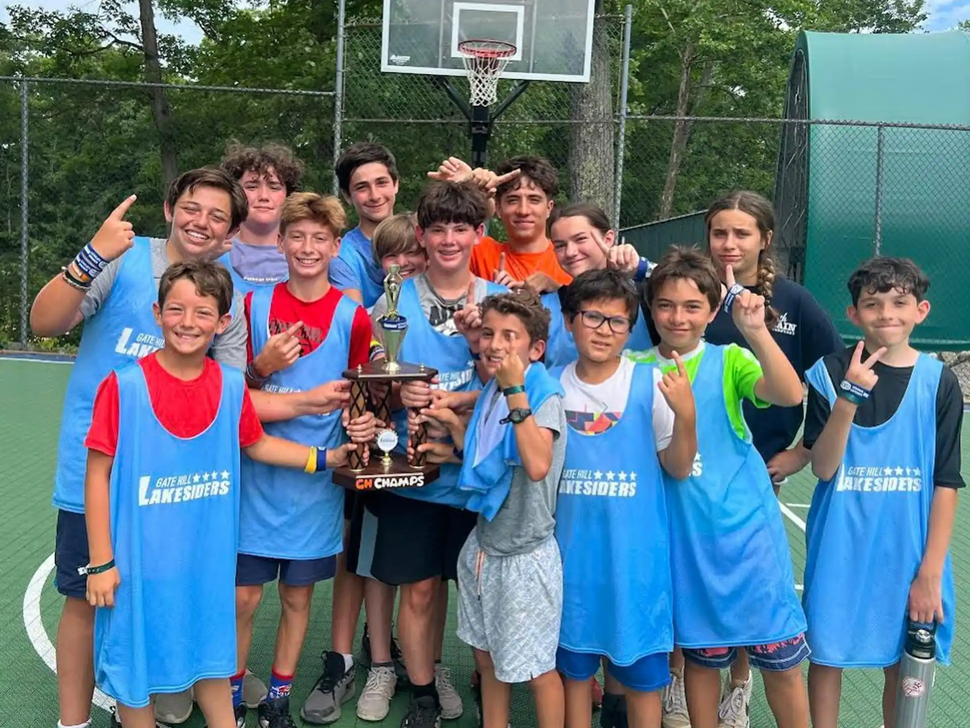 a group of kids holding trophies