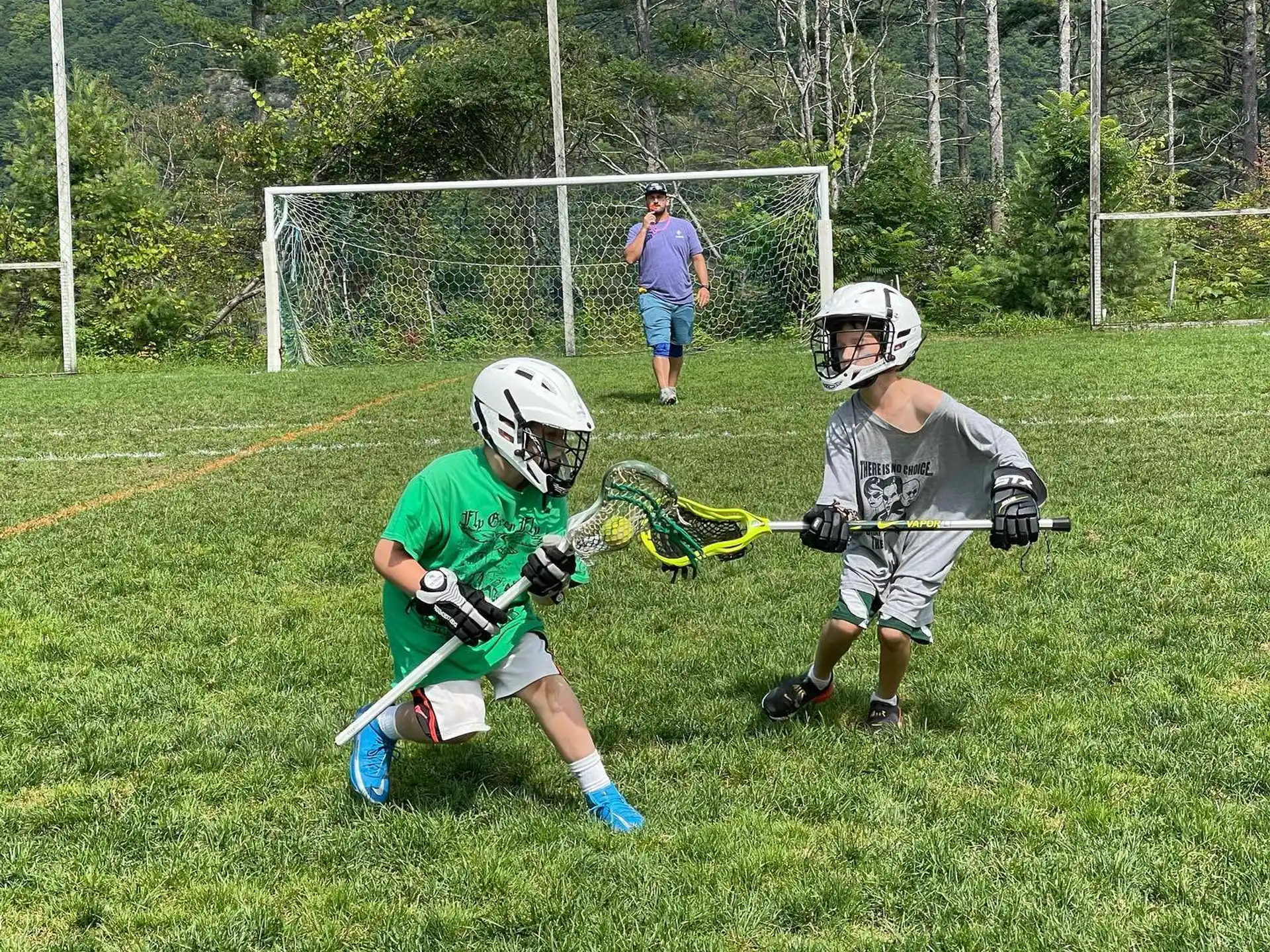 kids playing lacrosse on a field