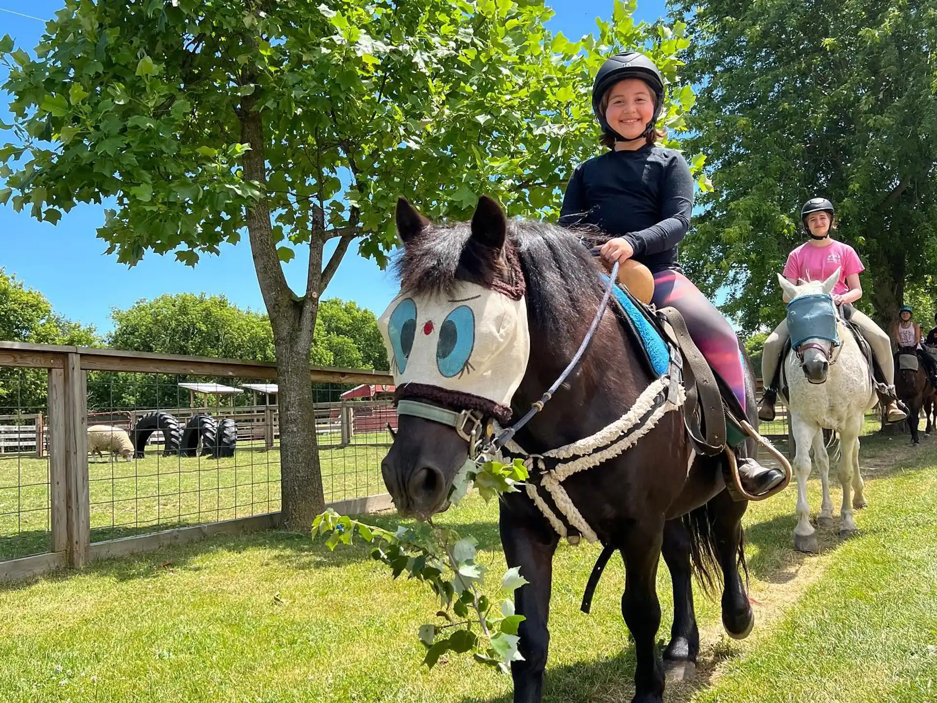 a couple of people riding horses