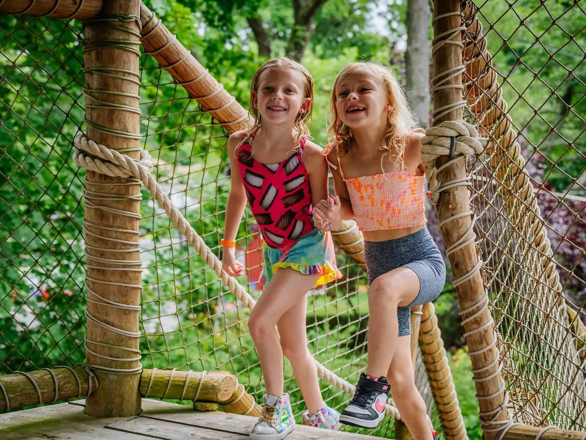 two girls in a jungle gym