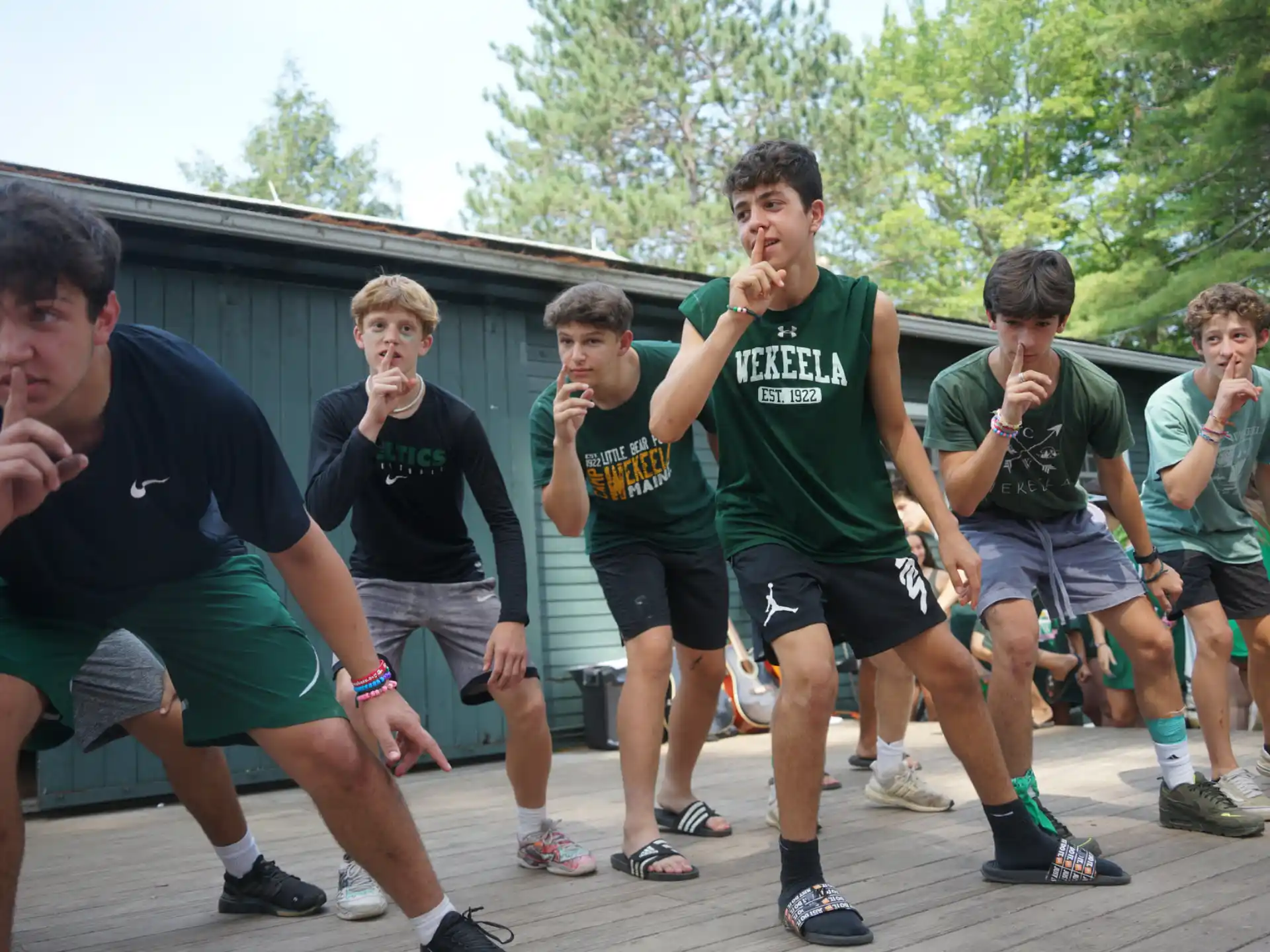 a group of men in green shirts