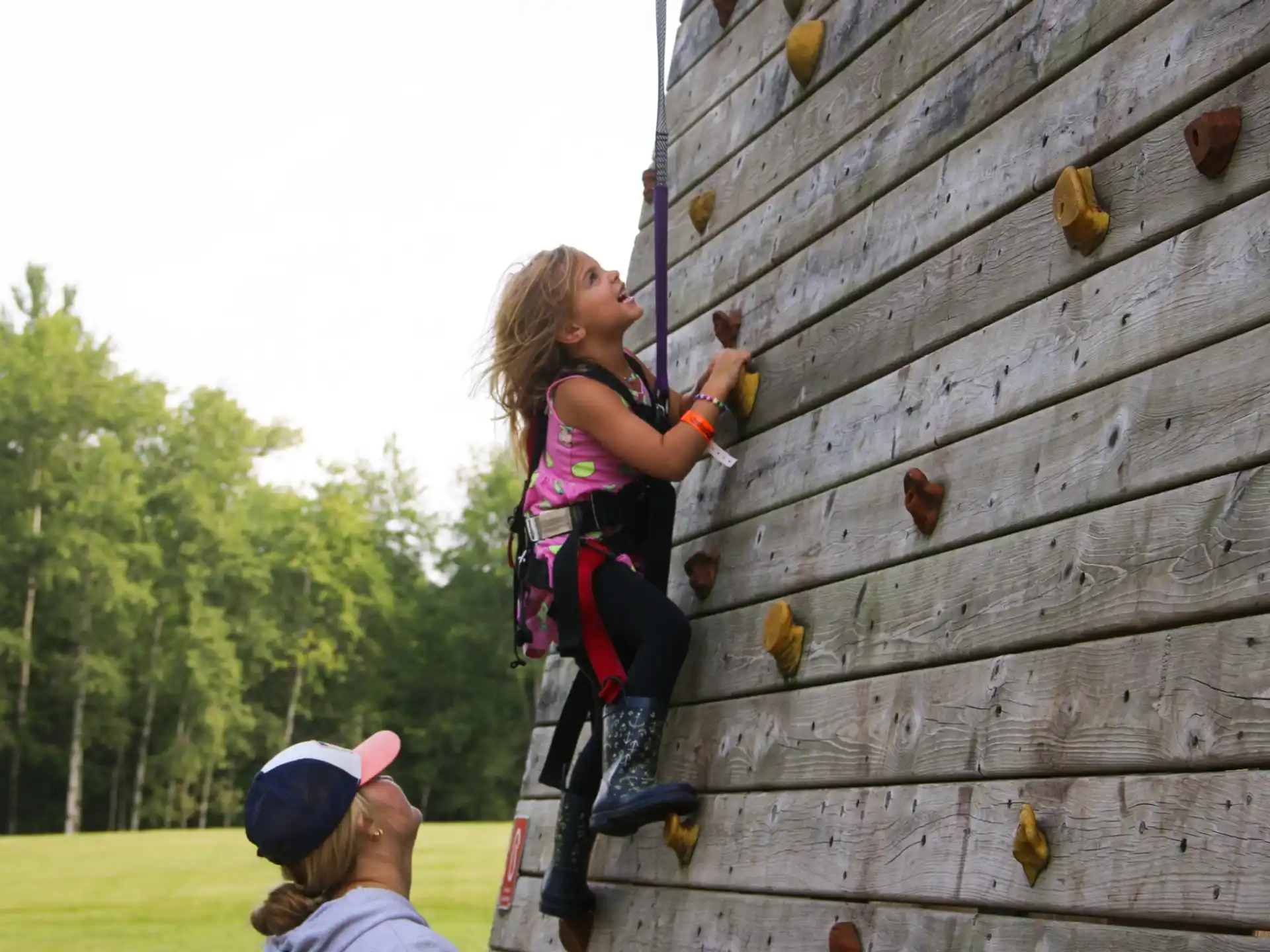 a girl climbing a fence