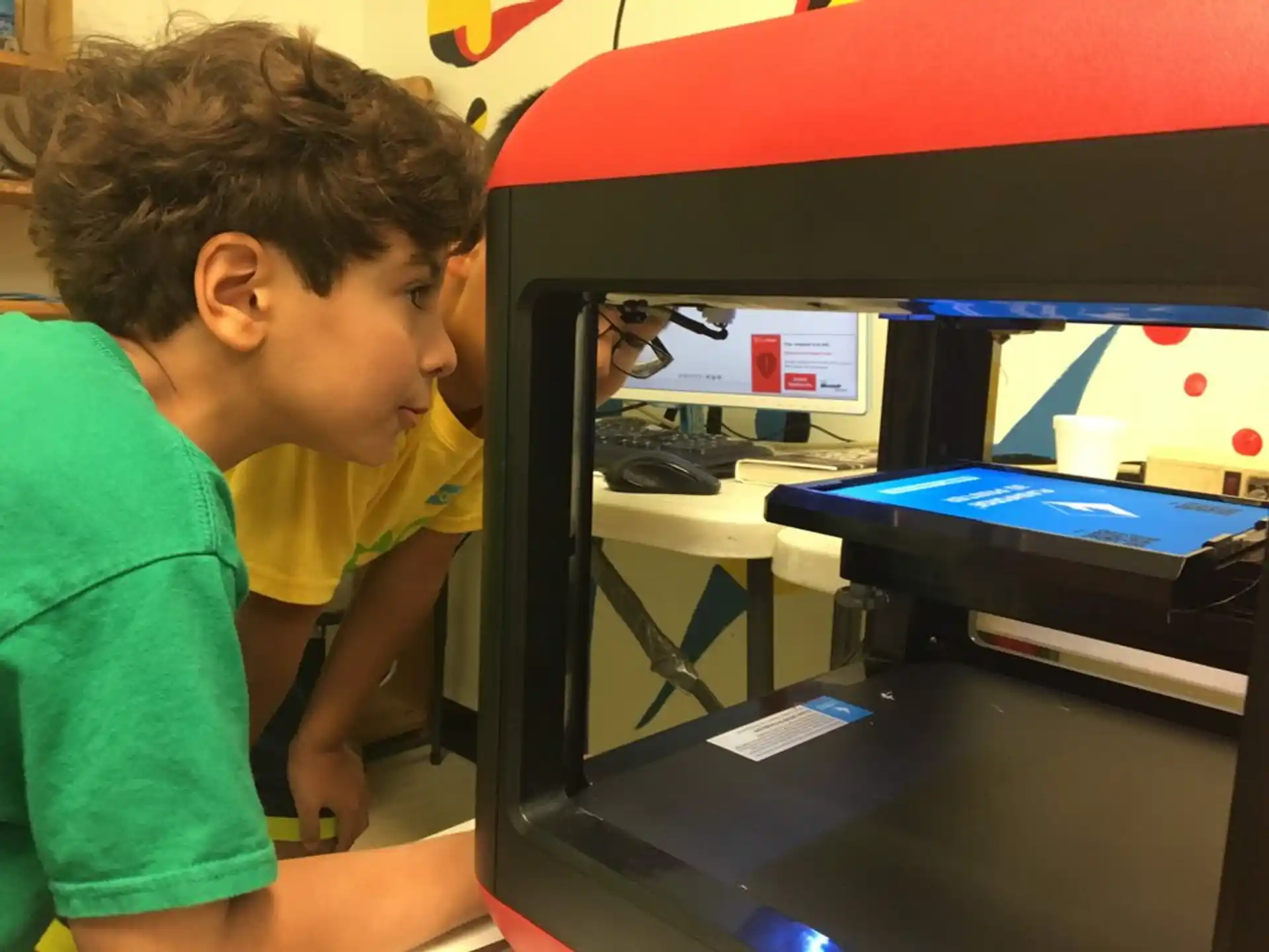 a young boy looking at a computer screen