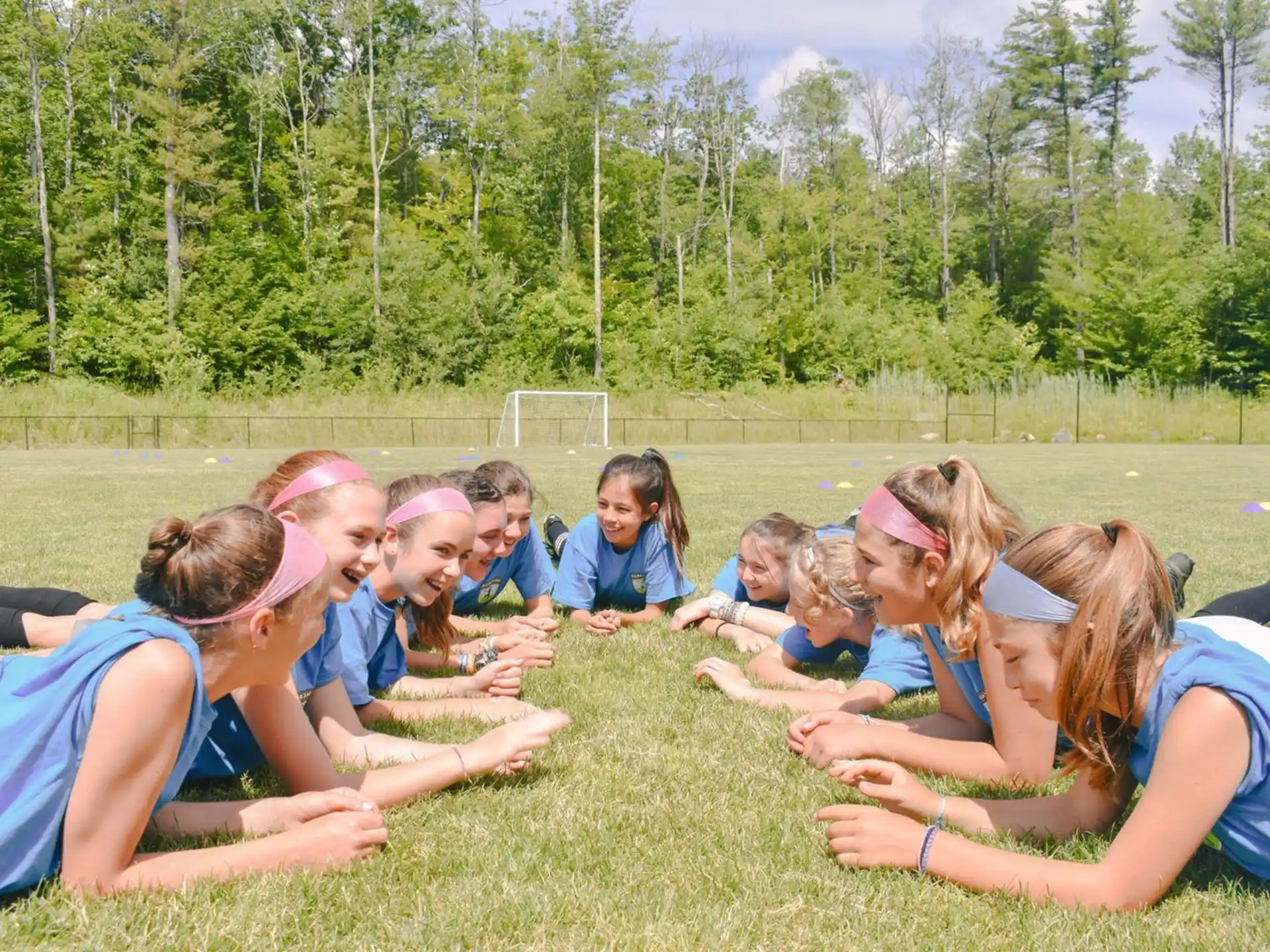 a group of girls sitting on the grass