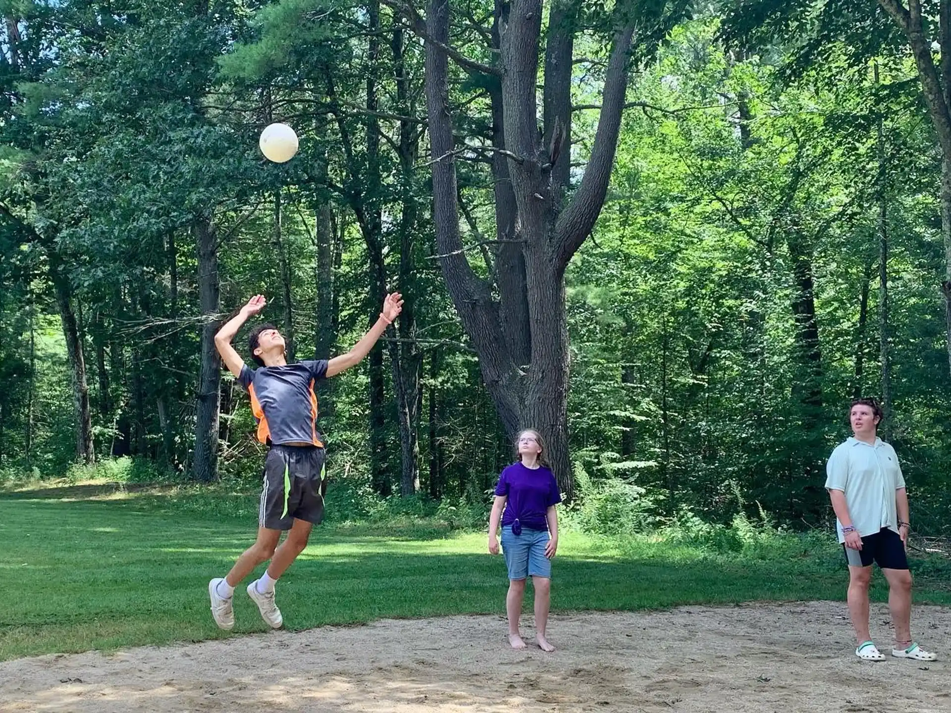 a group of people playing frisbee in a park