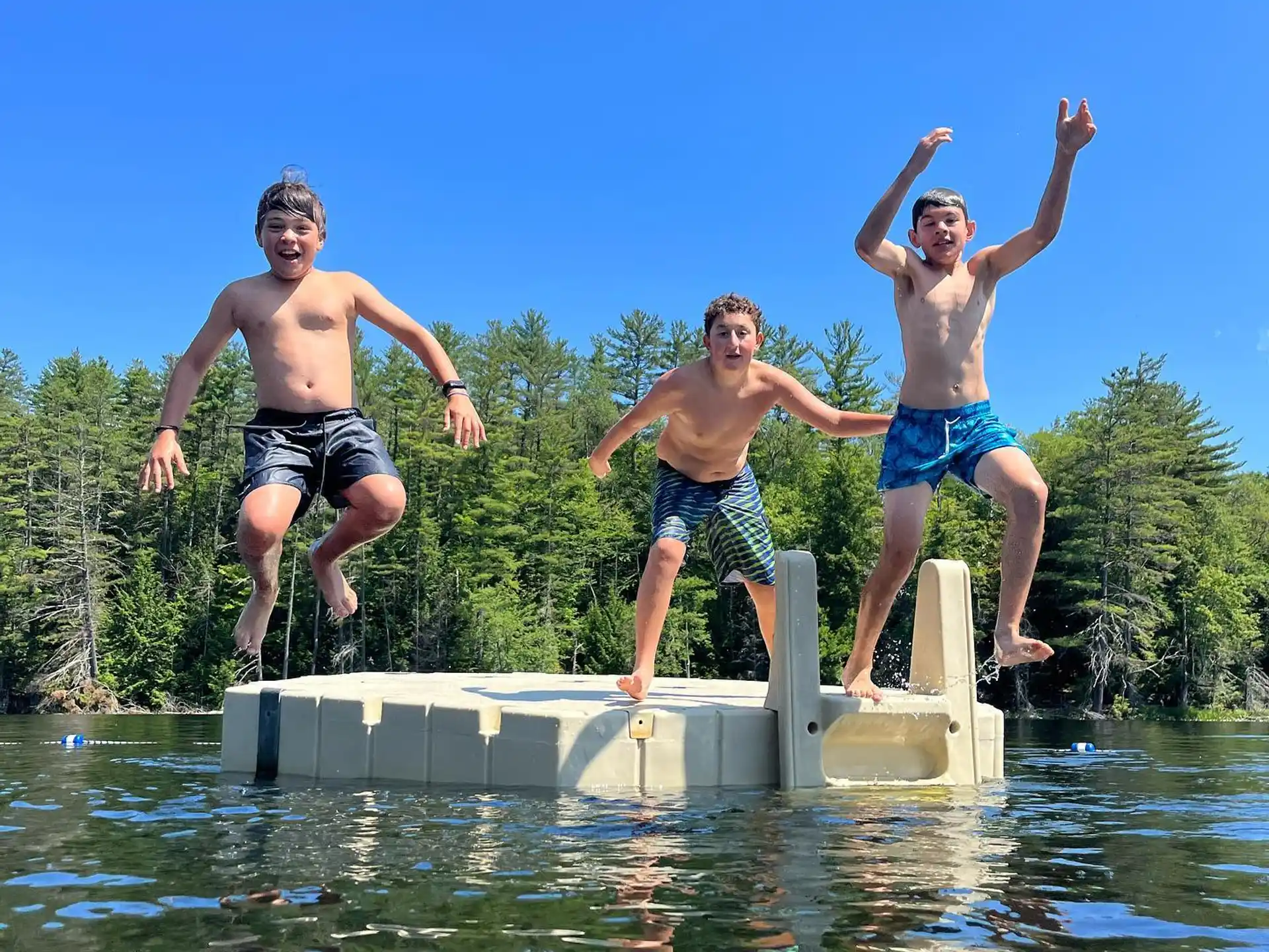 a group of men jumping into the water