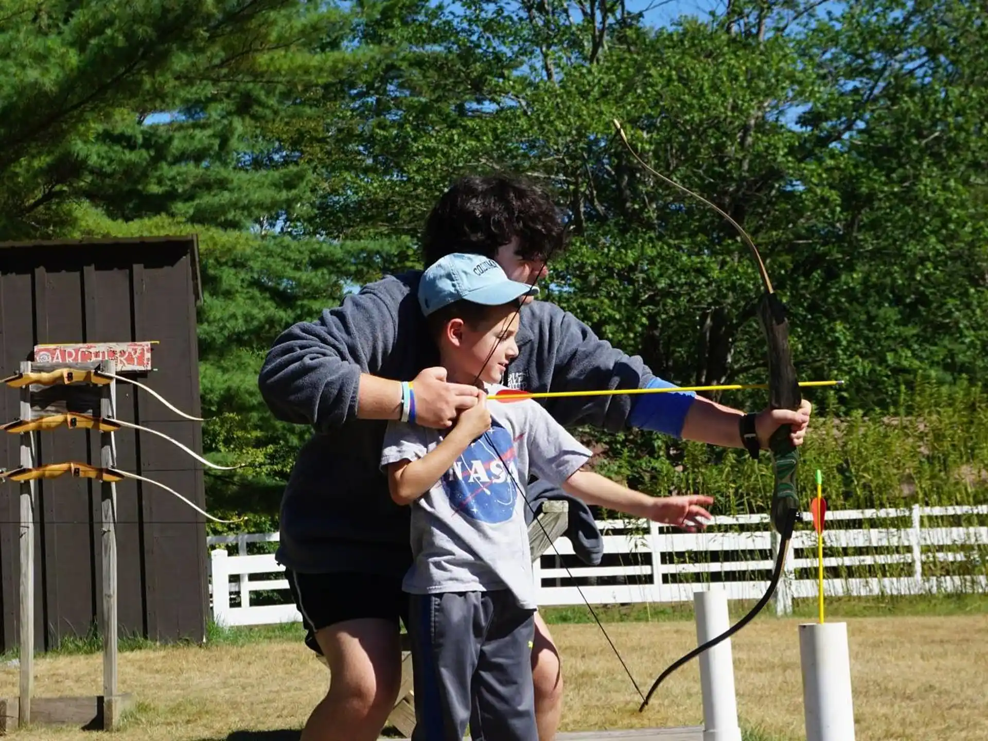 a man holding a boy on a swing